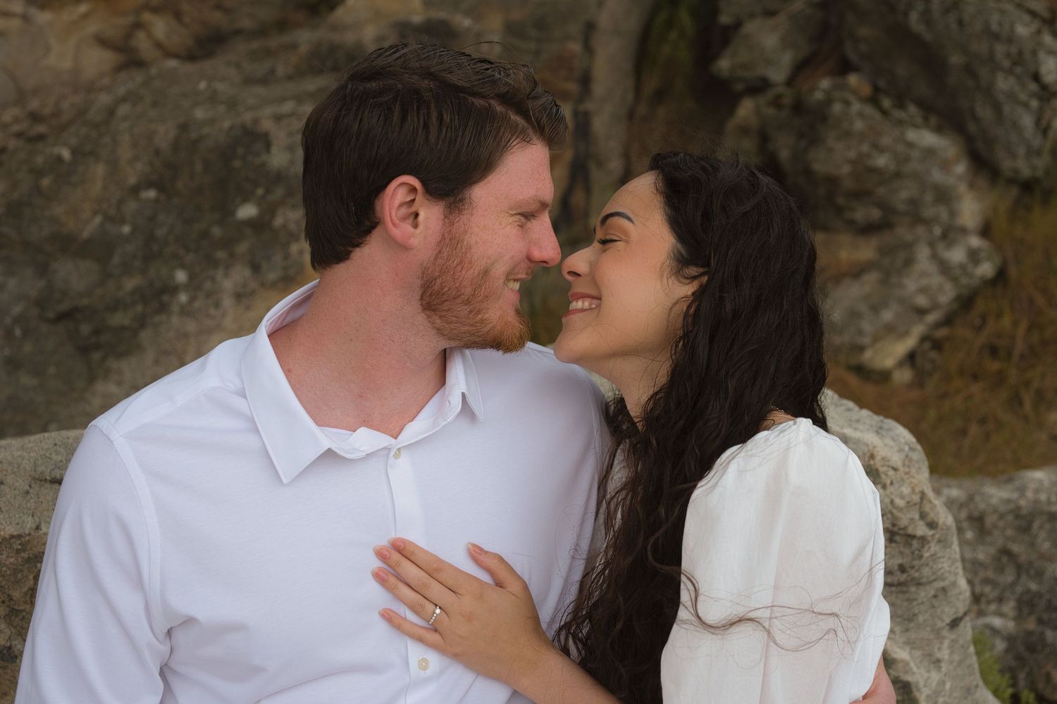 Couple smiling at each other during engagement session in North Idaho