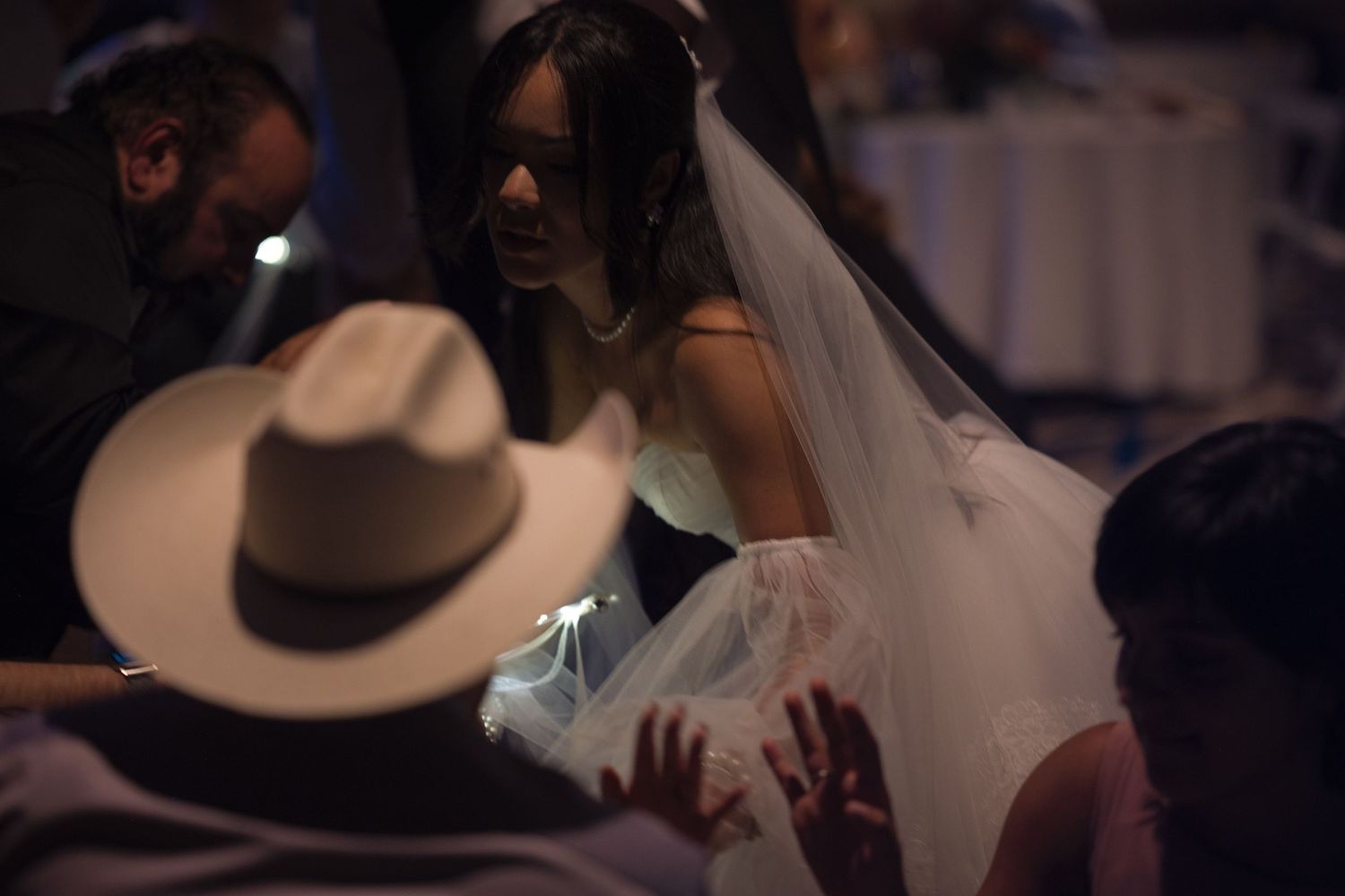 Bride dances with her guests during the dancing portion of reception, she is kneeling in correlation of the lyrics of a song.