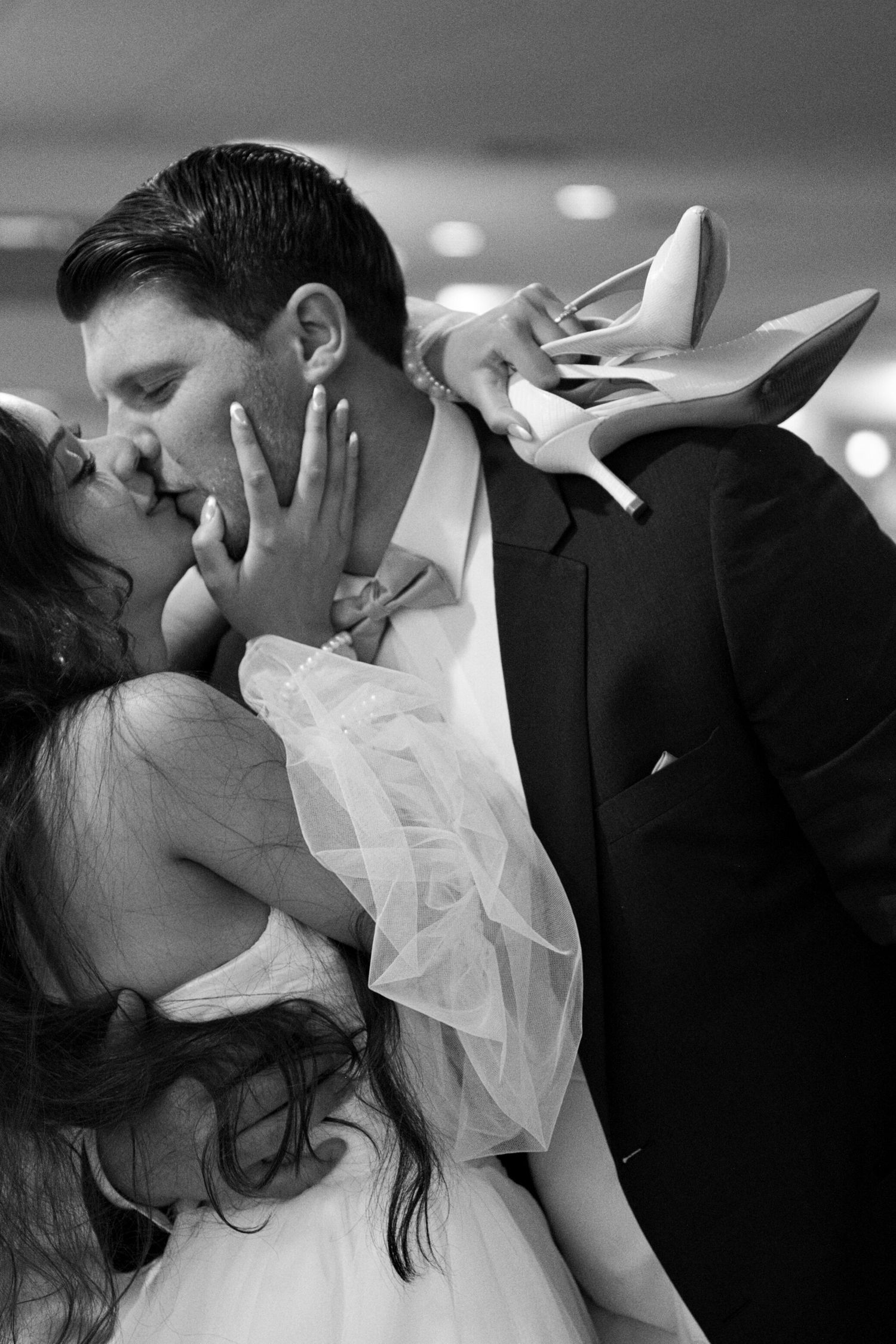 Bride kissing groom as they leave wedding reception in Coeur d' Alene, Idaho