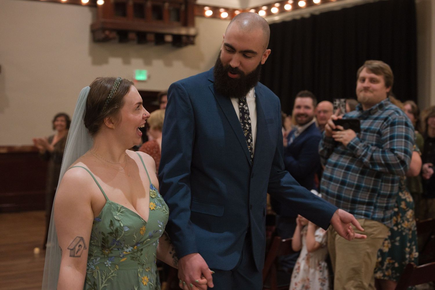 Couple smile at each other after wedding ceremony