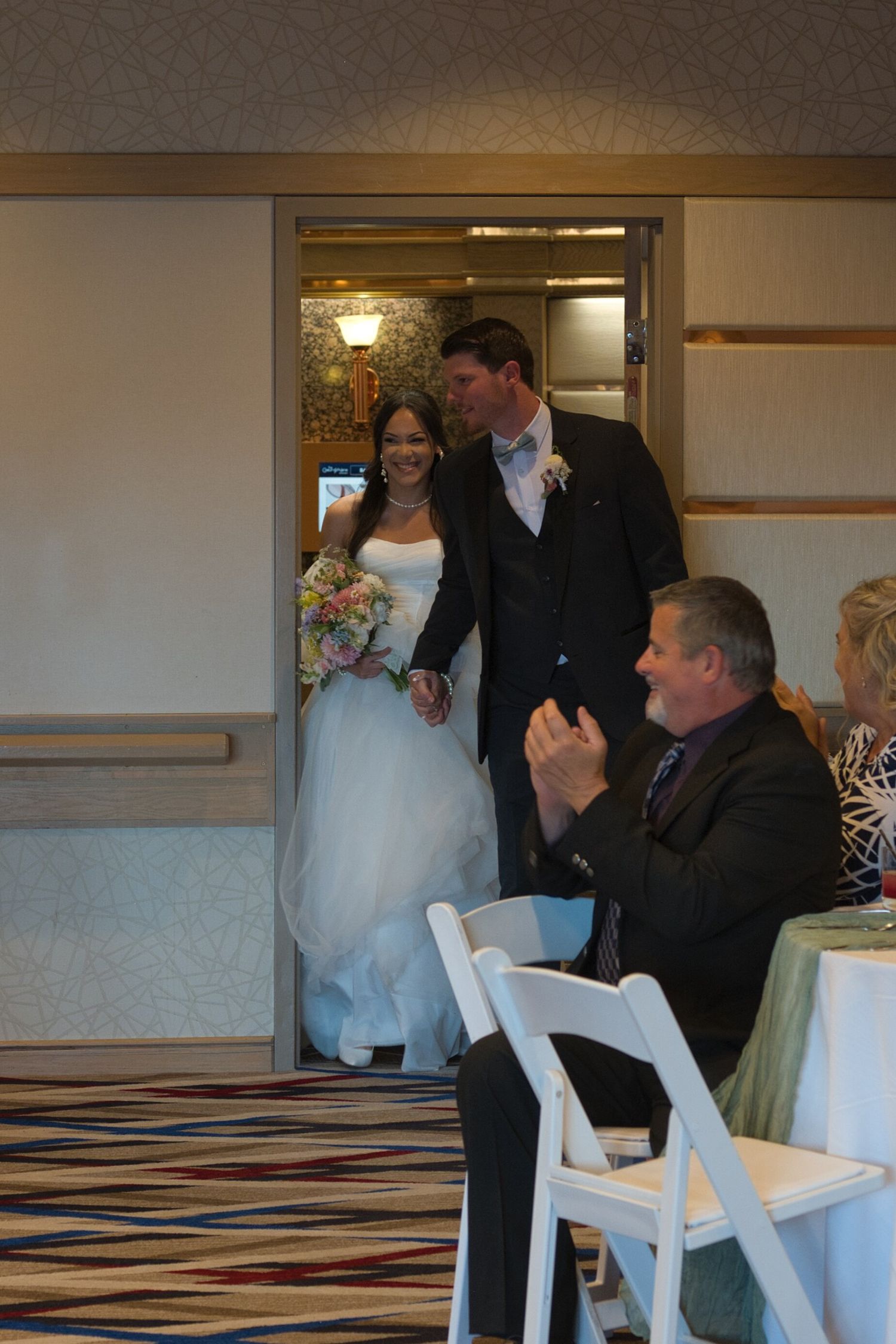 Bride and groom enter for the first time as a married couple into their reception.