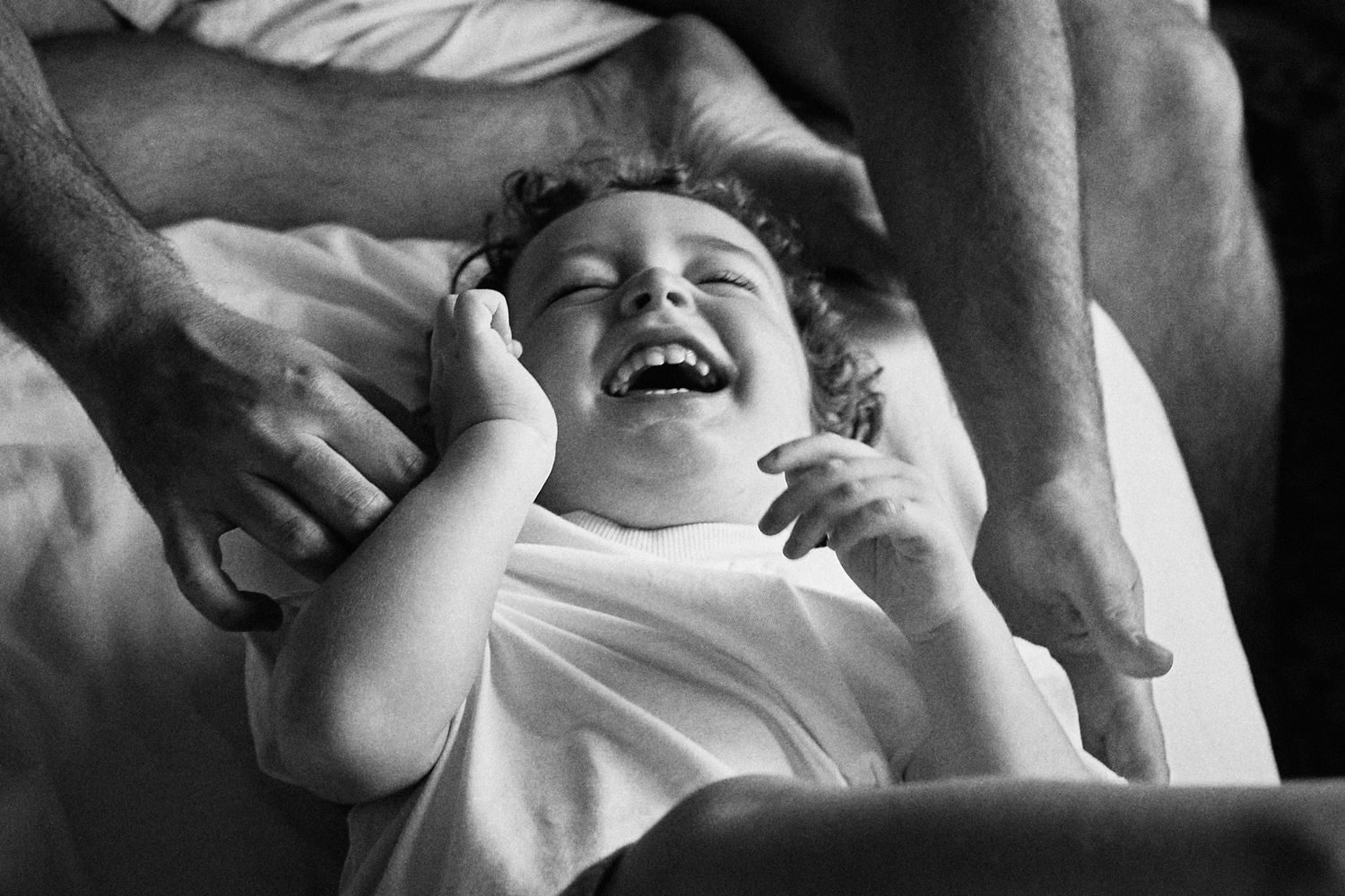 A black and white photo capturing pure joy and laughter during playtime.