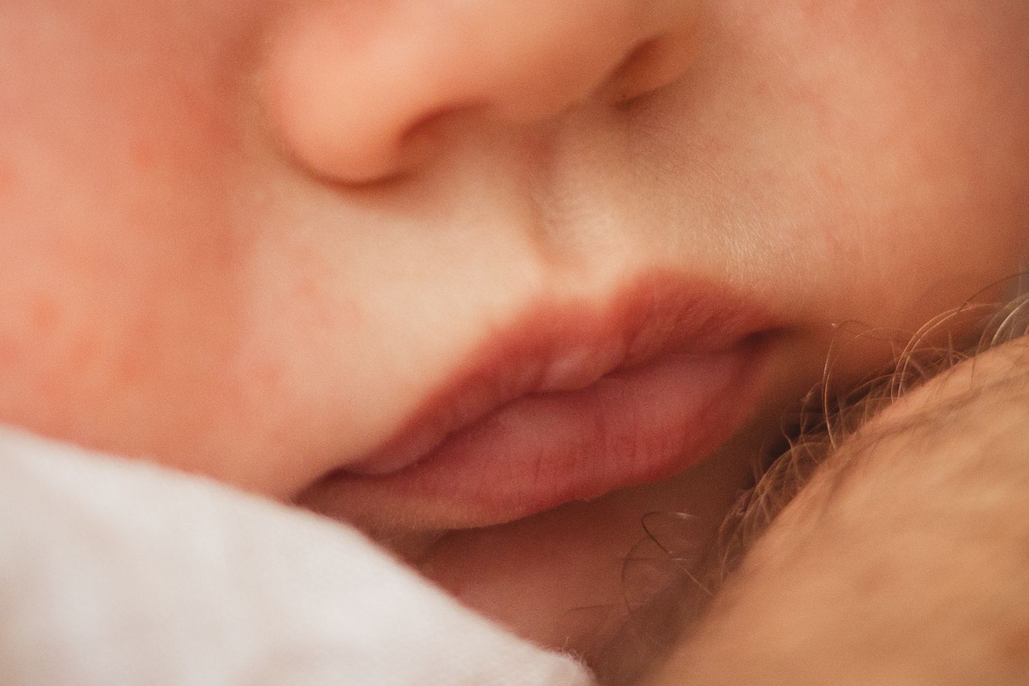 Extreme close-up of newborn baby's facial features.