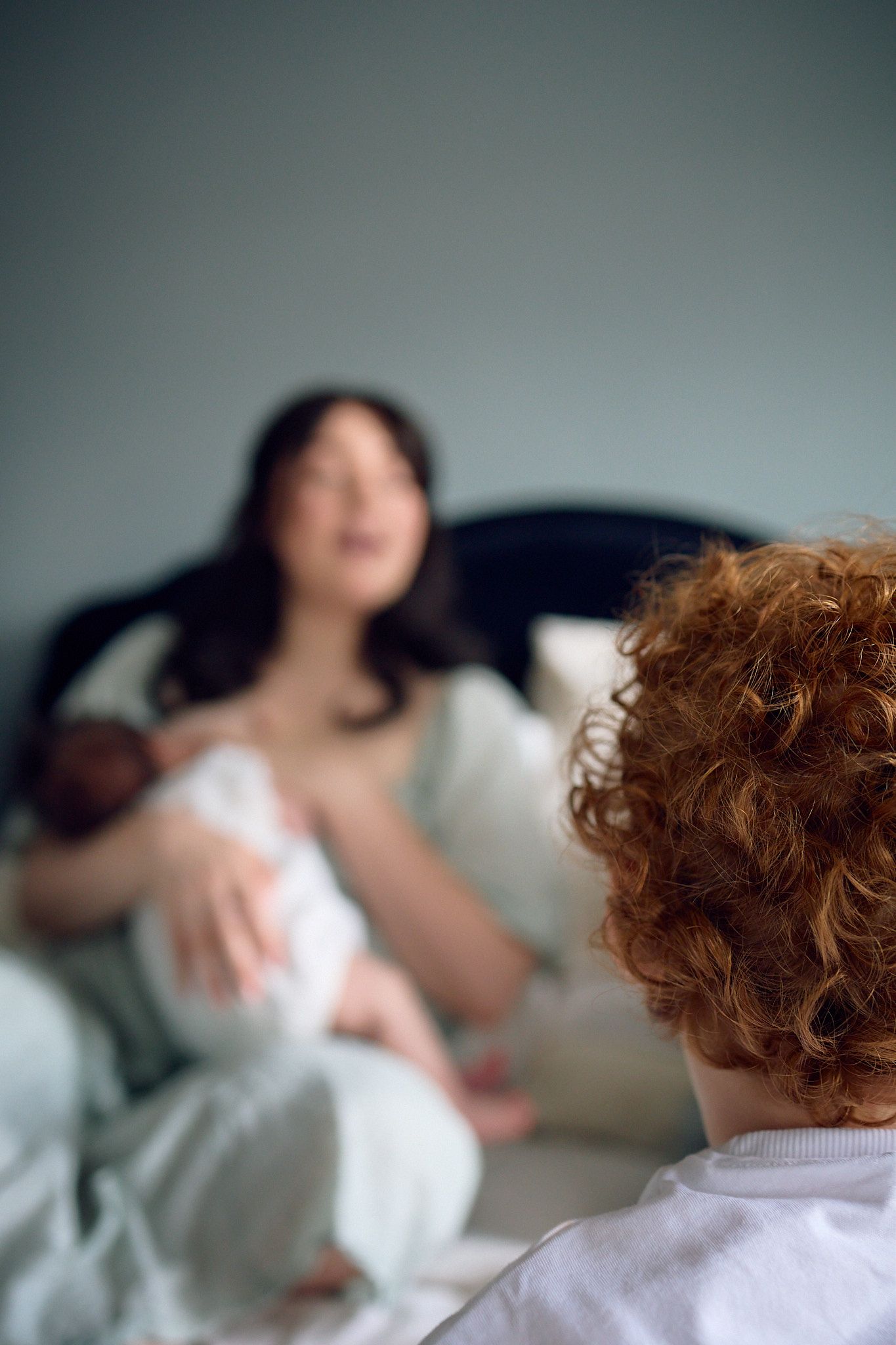 A quiet moment in a bedroom with soft lighting and gentle interactions.