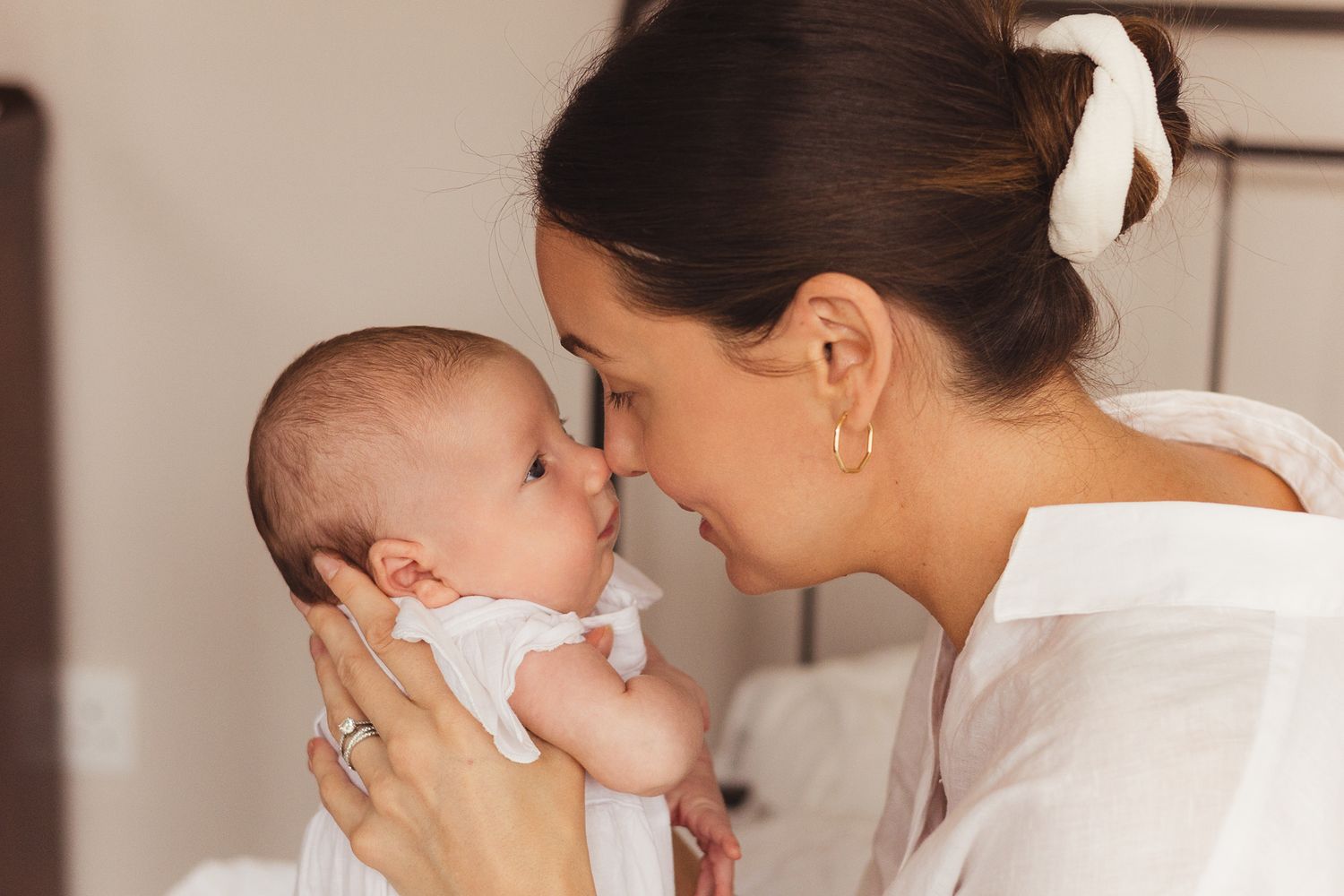 Close-up series of mother cradling and nurturing newborn baby.