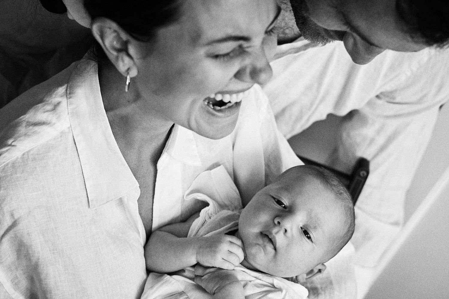 Black and white candid moments of family affection and laughter.