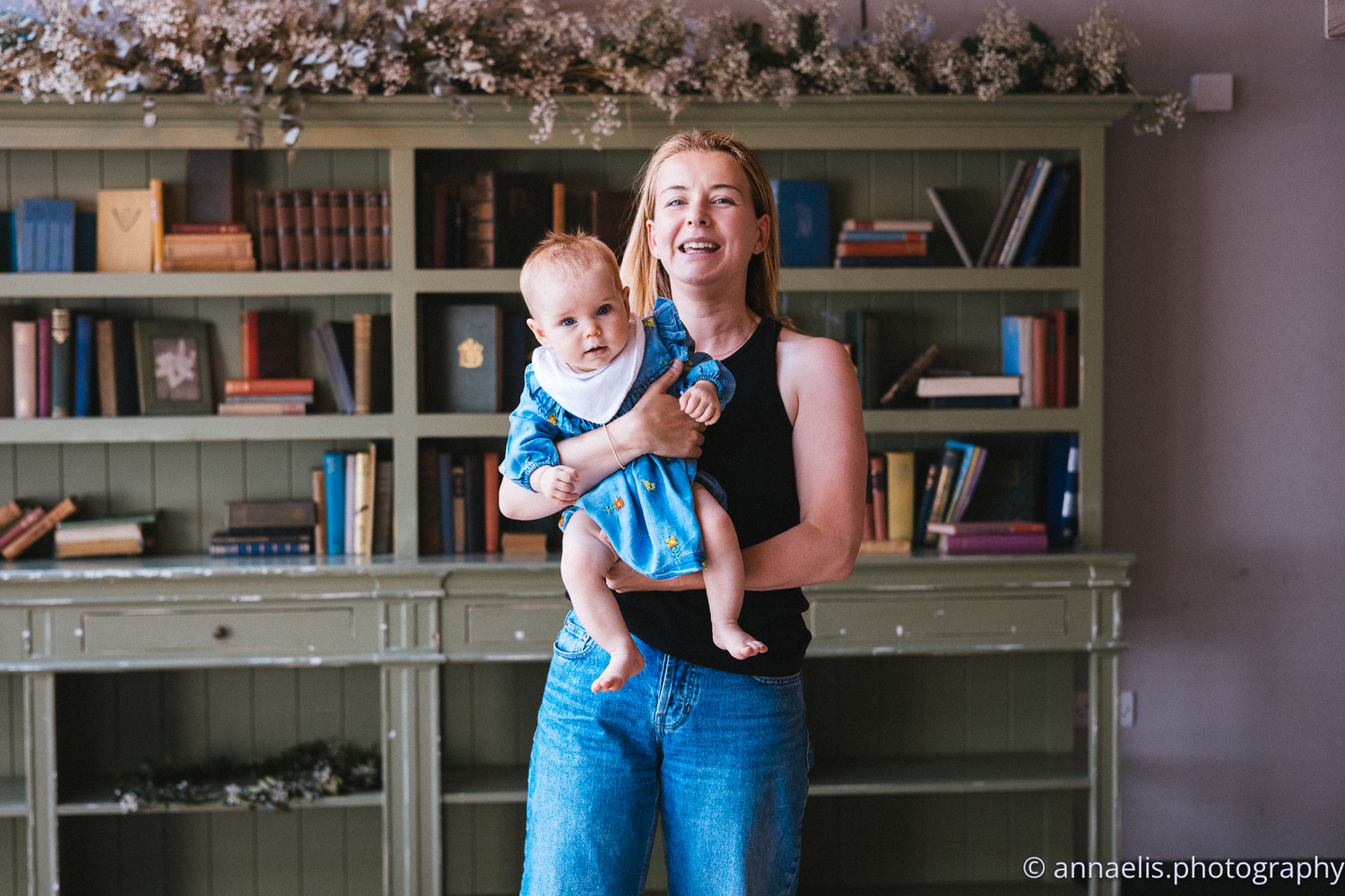 Series of candid moments between parent and baby in front of built-in bookshelves.