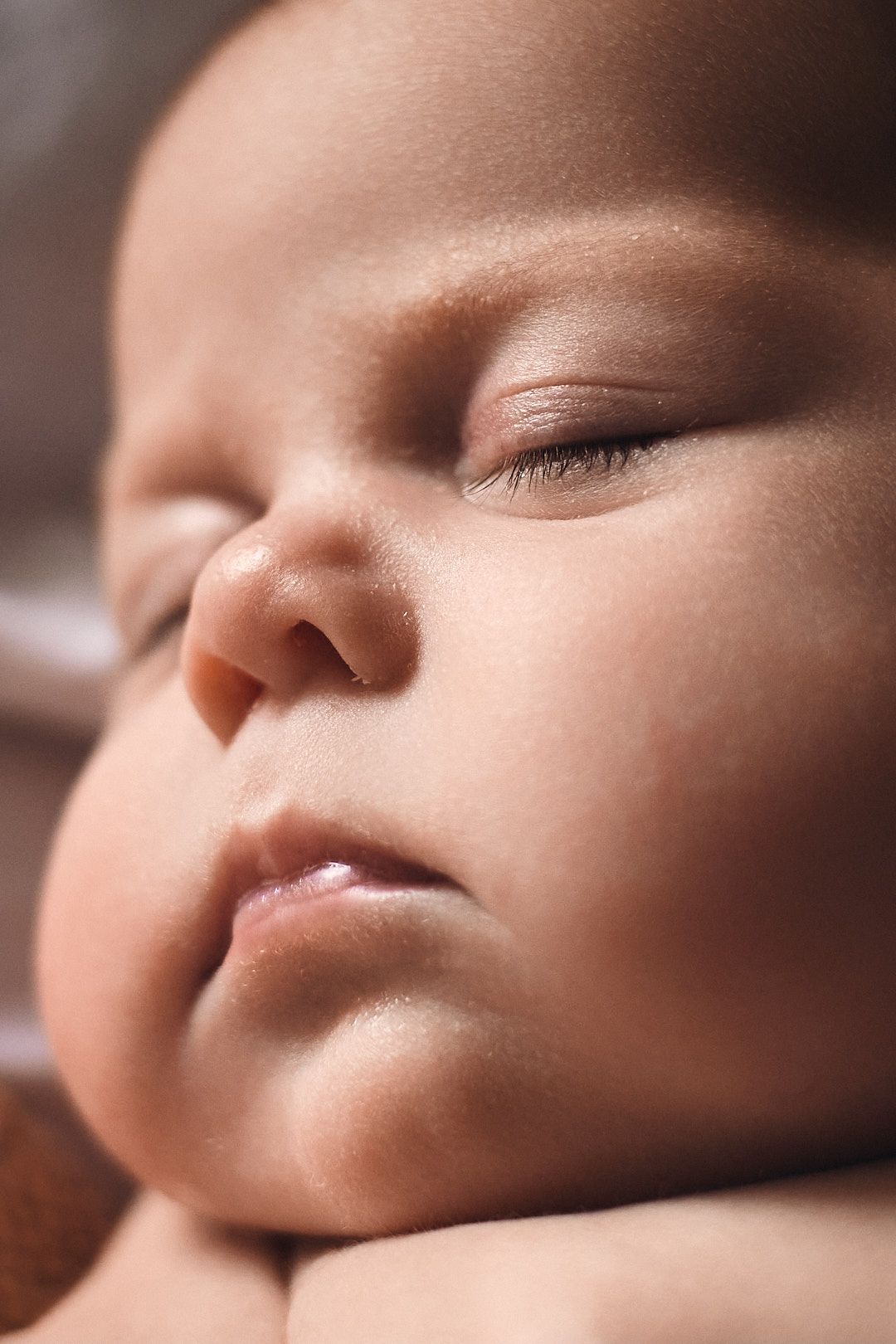 Artistic macro shots of sleeping baby's peaceful facial features.
