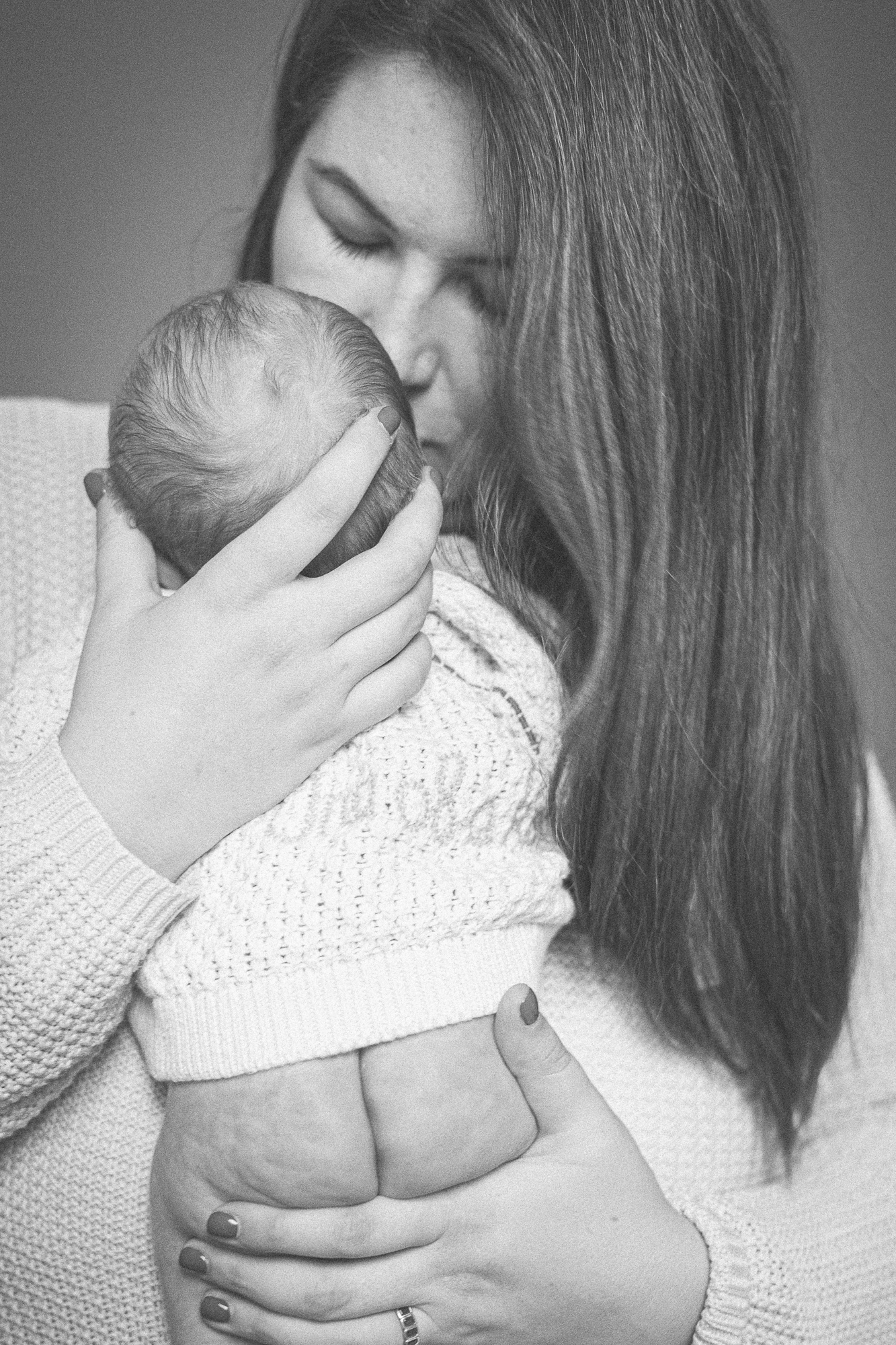 Intimate black and white portraits showing nurturing moments between parent and child.