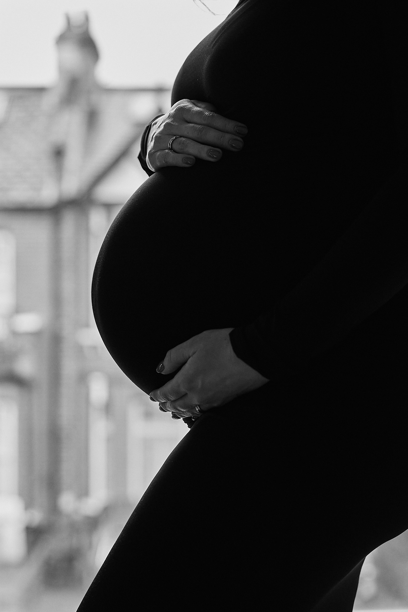 A series of black and white silhouettes showing a pregnant woman's growing belly during different stages of pregnancy.