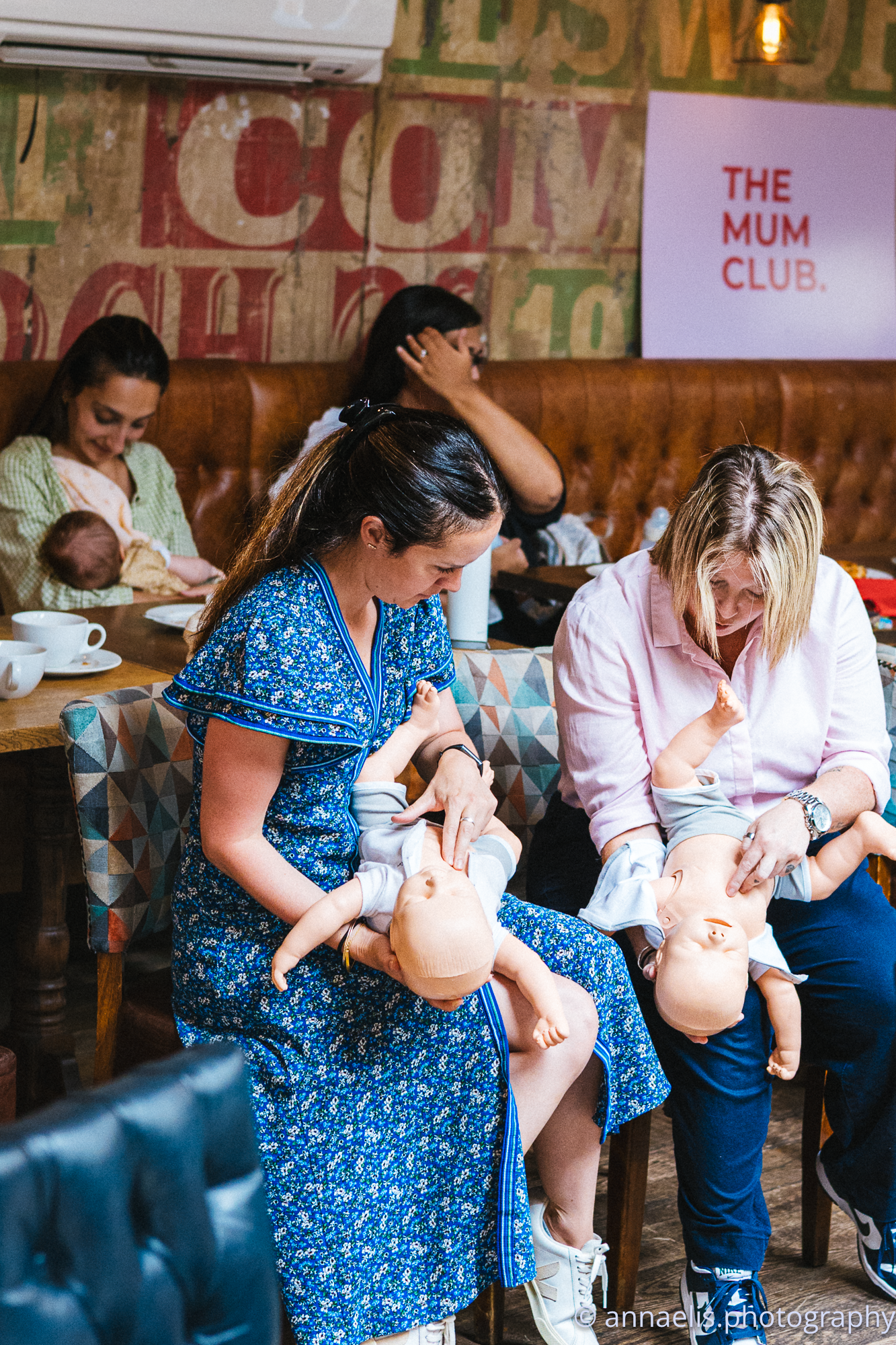 A group meets in a rustic cafe with exposed brick walls and vintage decor.