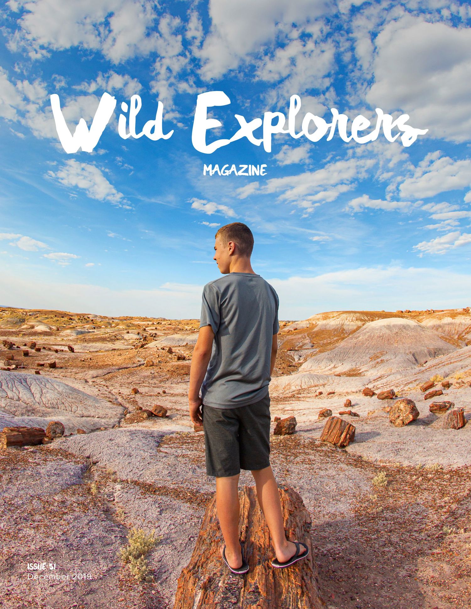 Magazine cover showing person standing on rocky terrain against blue sky with white text overlay.
