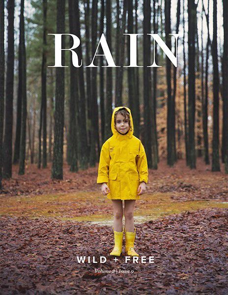 Magazine cover showing figure in bright yellow raincoat standing in misty forest.