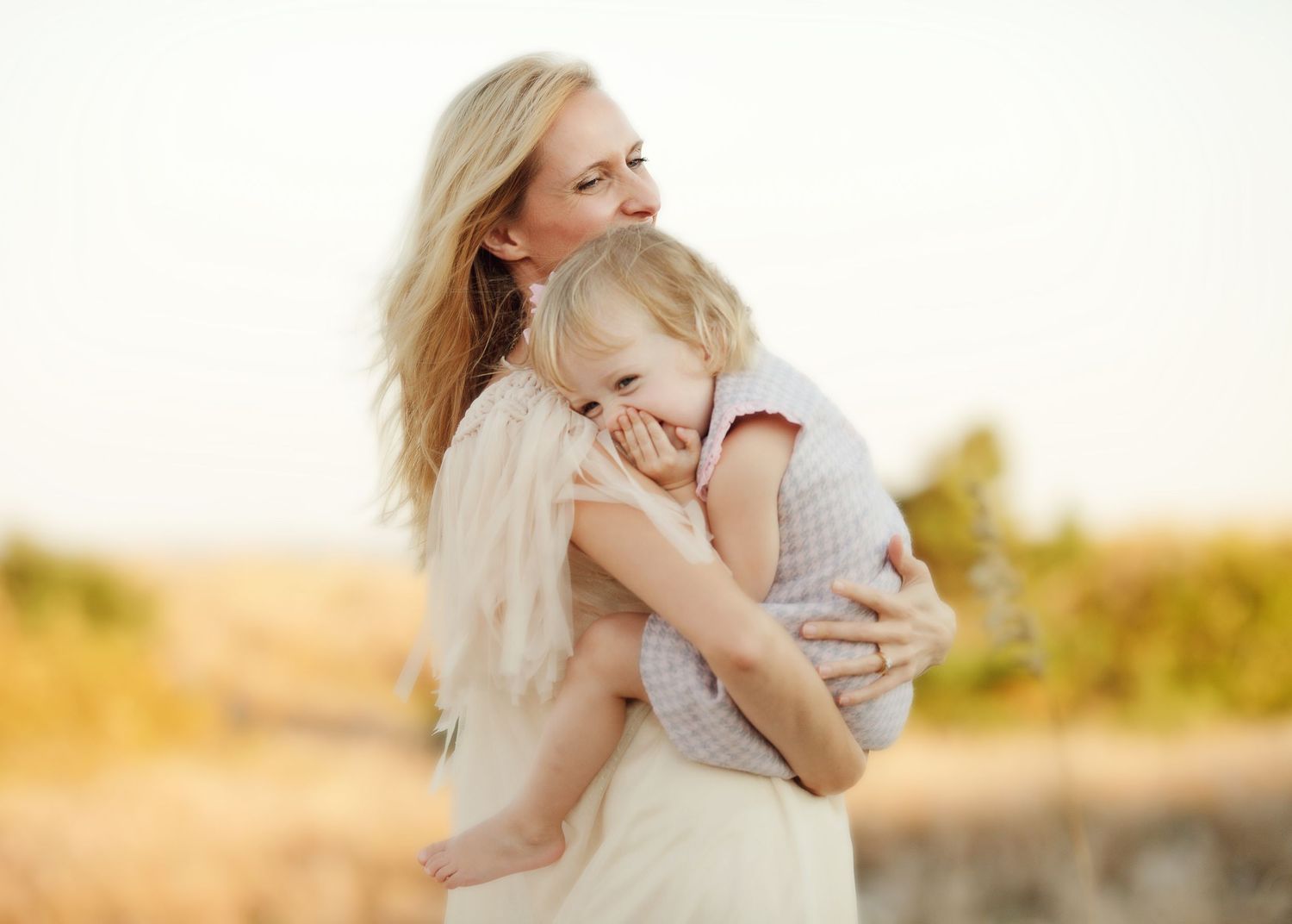 Warm sunset portrait showing a gentle embrace and connection outdoors.