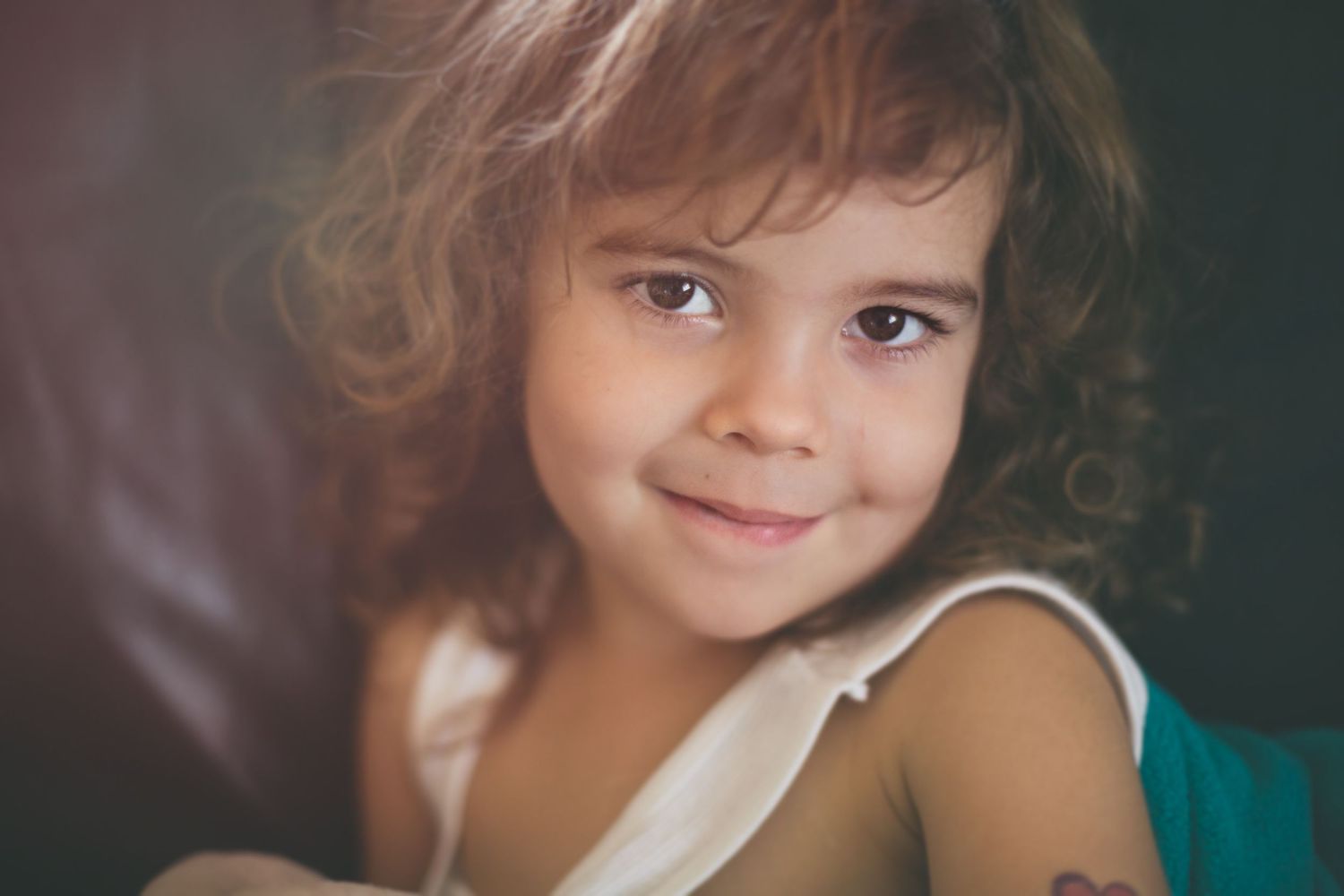 Close-up portrait with soft lighting and gentle smile.