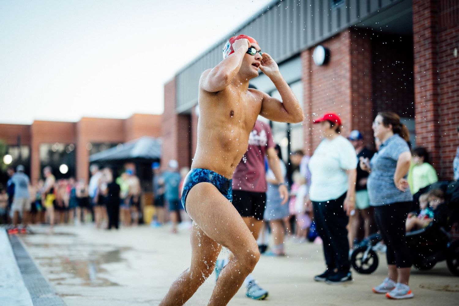 Athlete cooling off with water during outdoor summer competition.