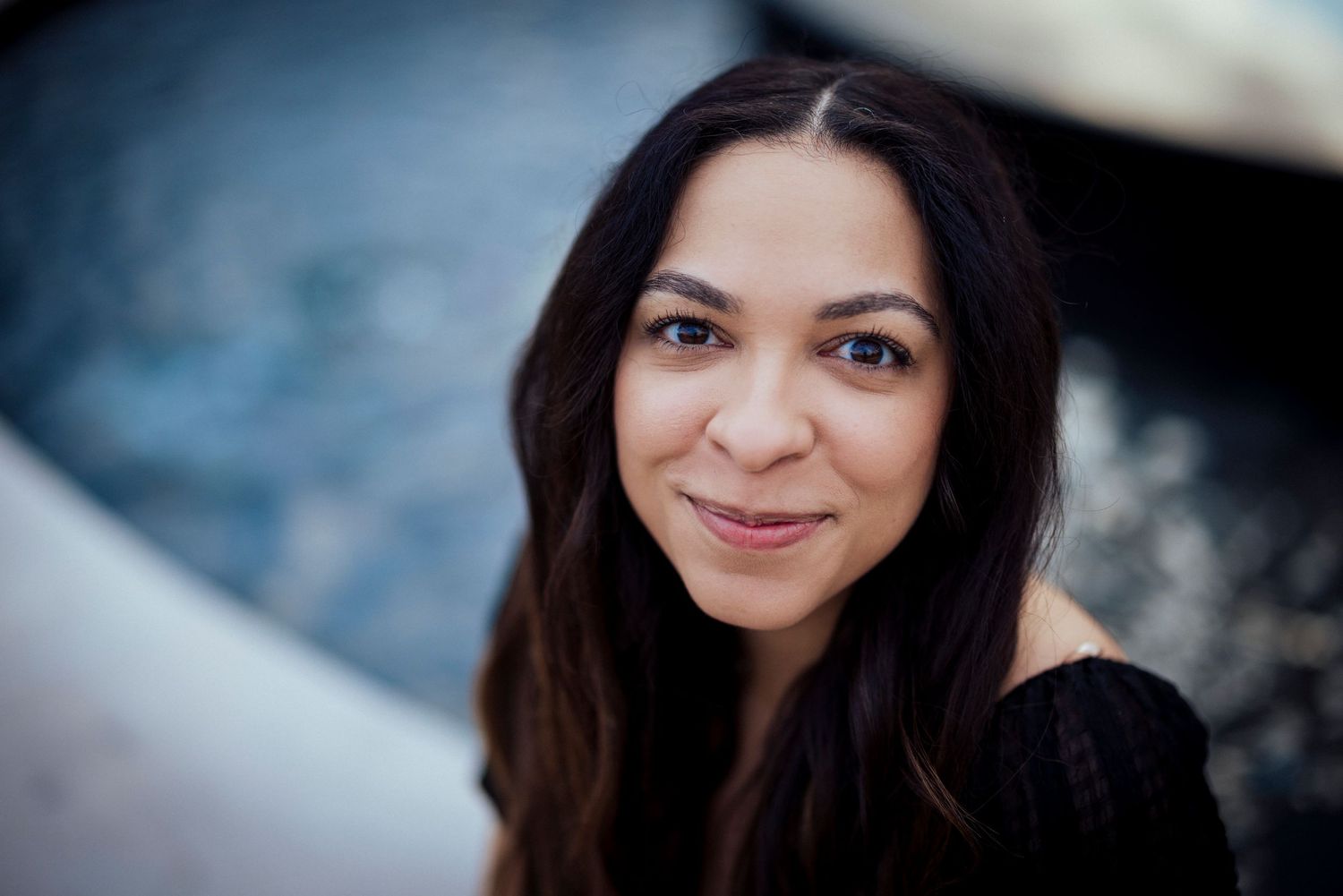 Outdoor portrait with soft focus background and natural lighting.