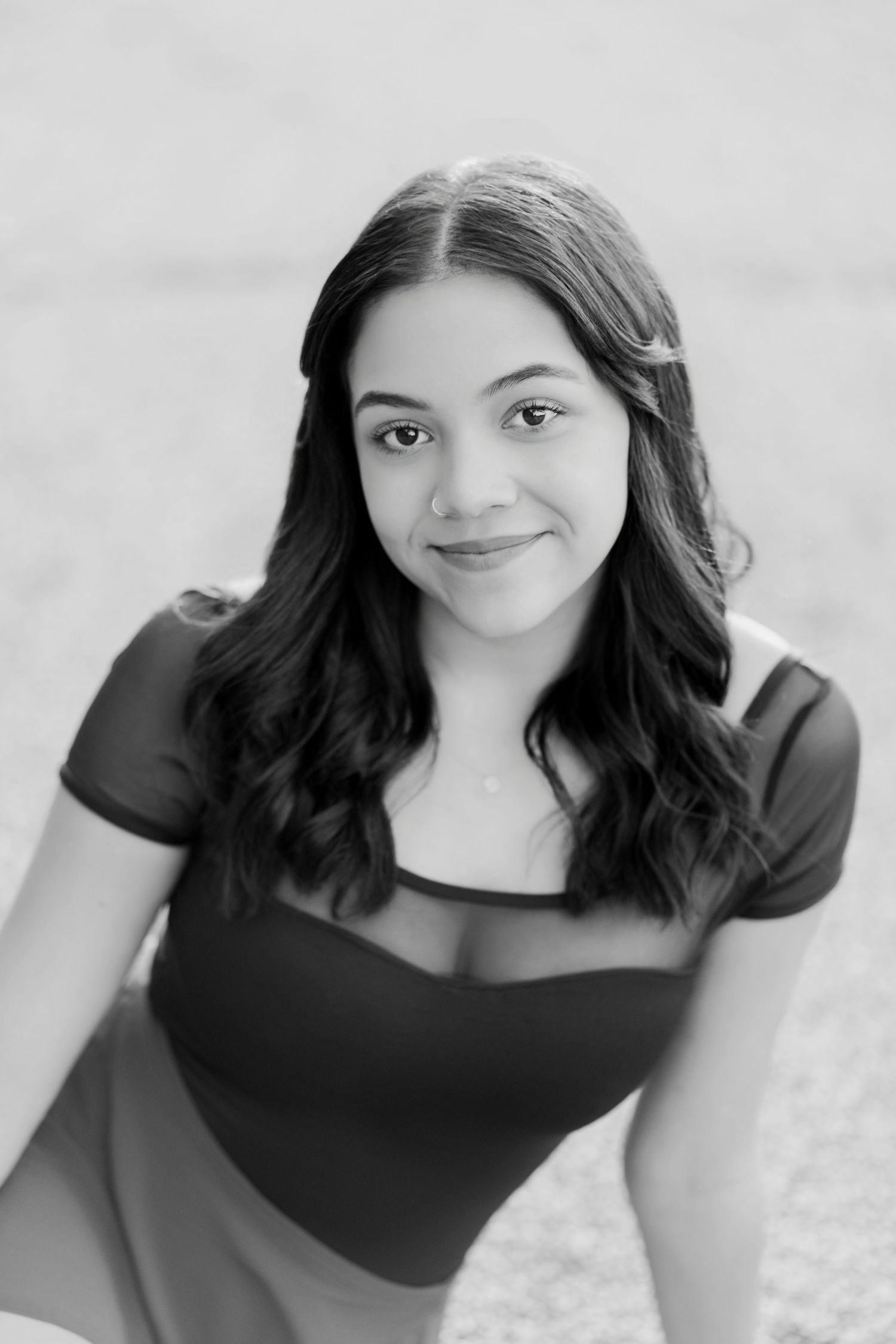 A series of black and white portraits showing different expressions and poses against a light background.