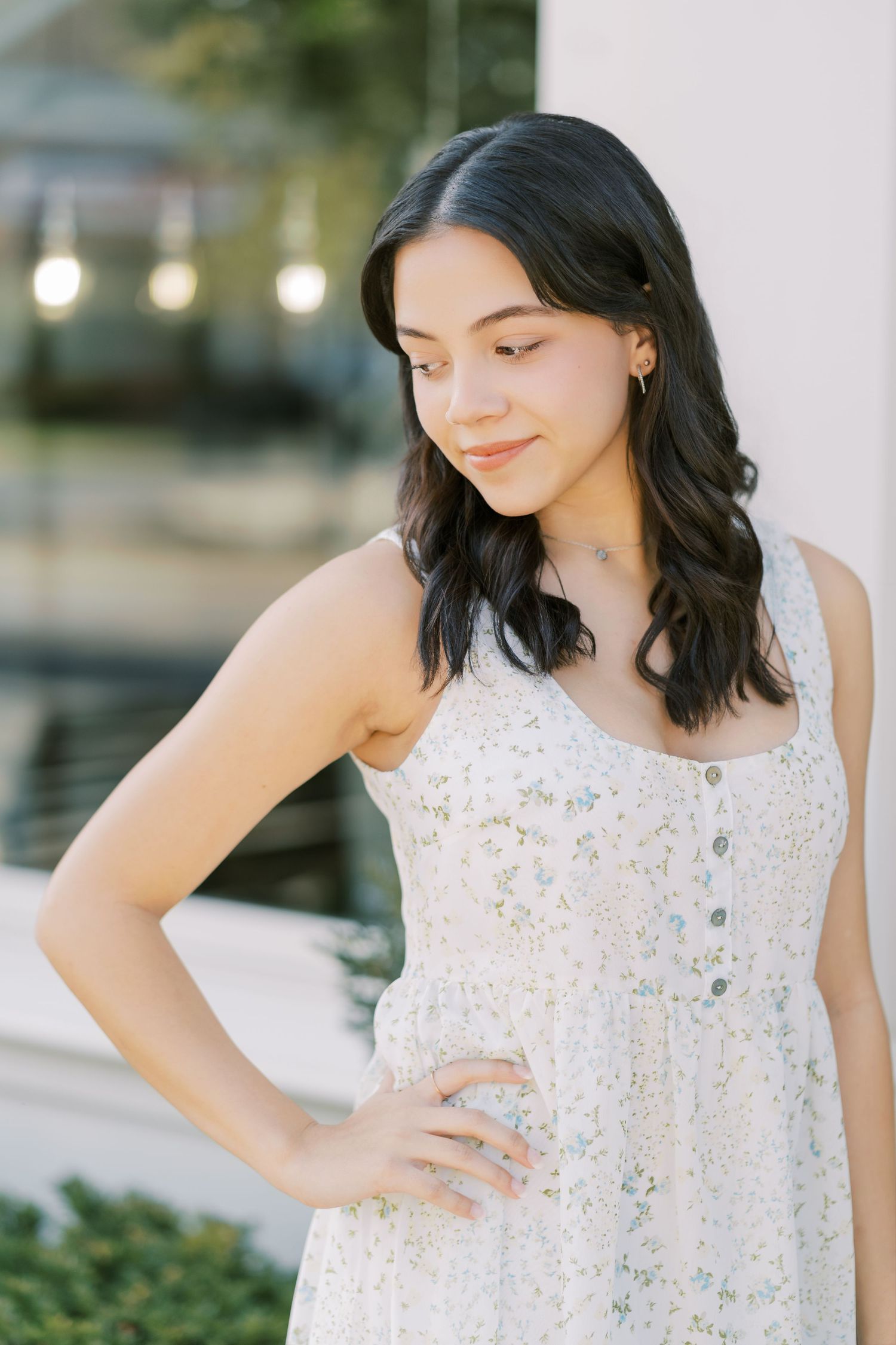A series of outdoor portraits showing someone in a delicate white floral sundress against a soft natural background.