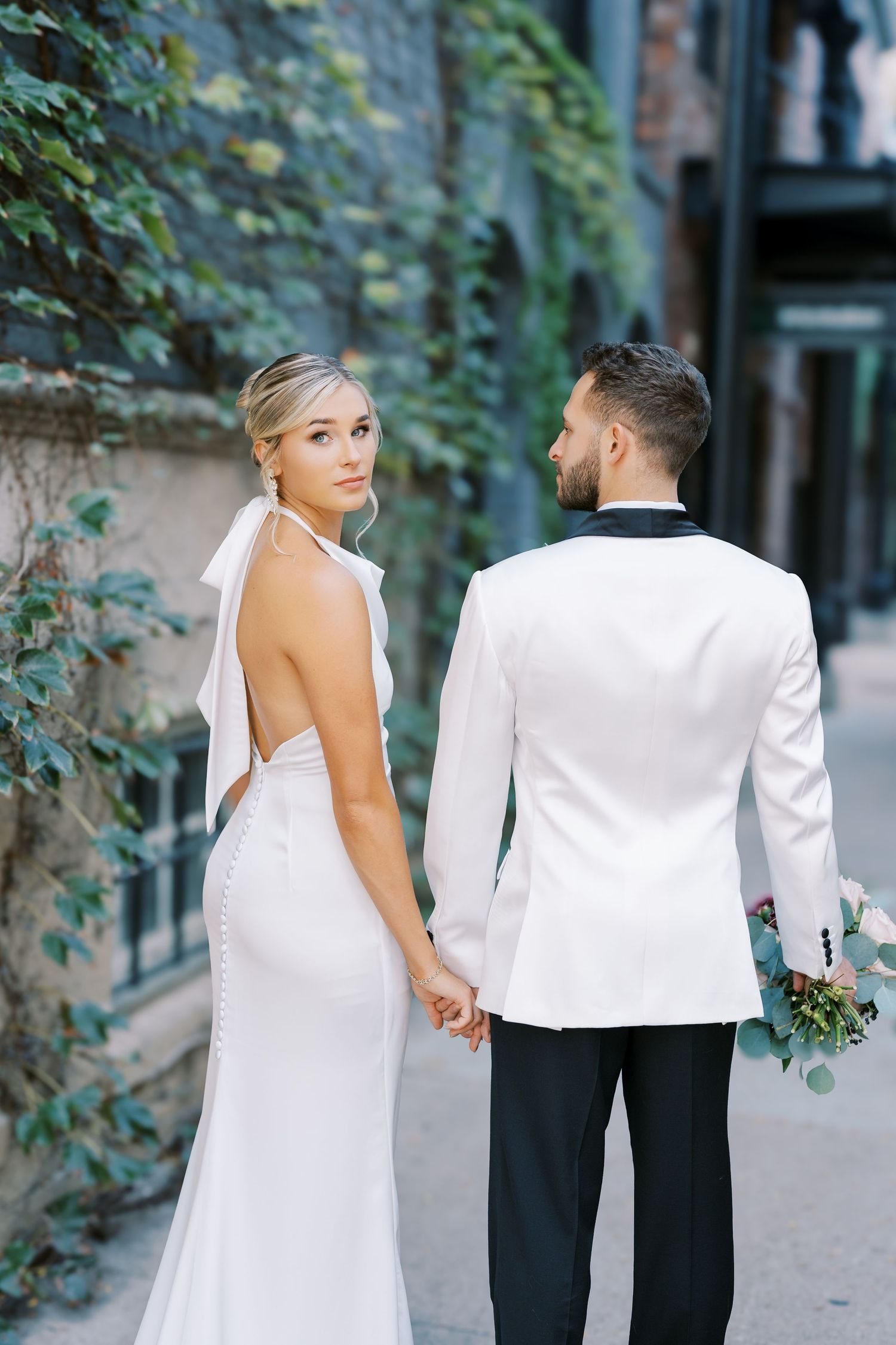 A bride and groom share intimate moments in a series of romantic outdoor wedding photos with ivy-covered walls.