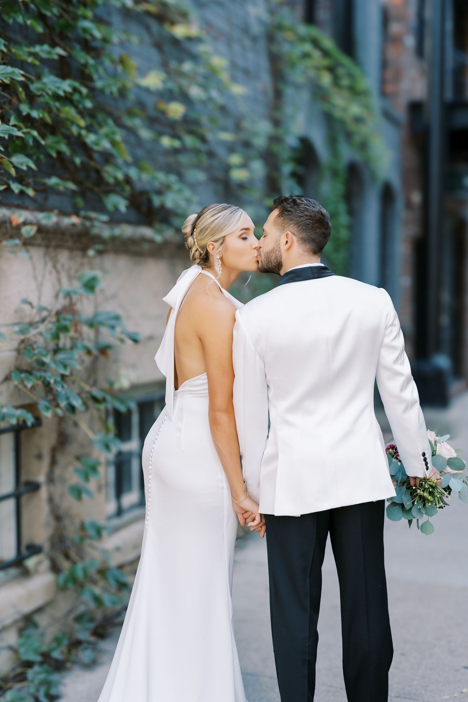 A romantic wedding couple shares intimate moments in a series of artistic outdoor photos along a stone wall.