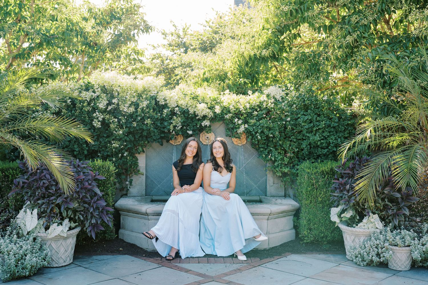 A series of outdoor wedding photos showing people in white dresses sitting on stone benches in a lush garden setting.