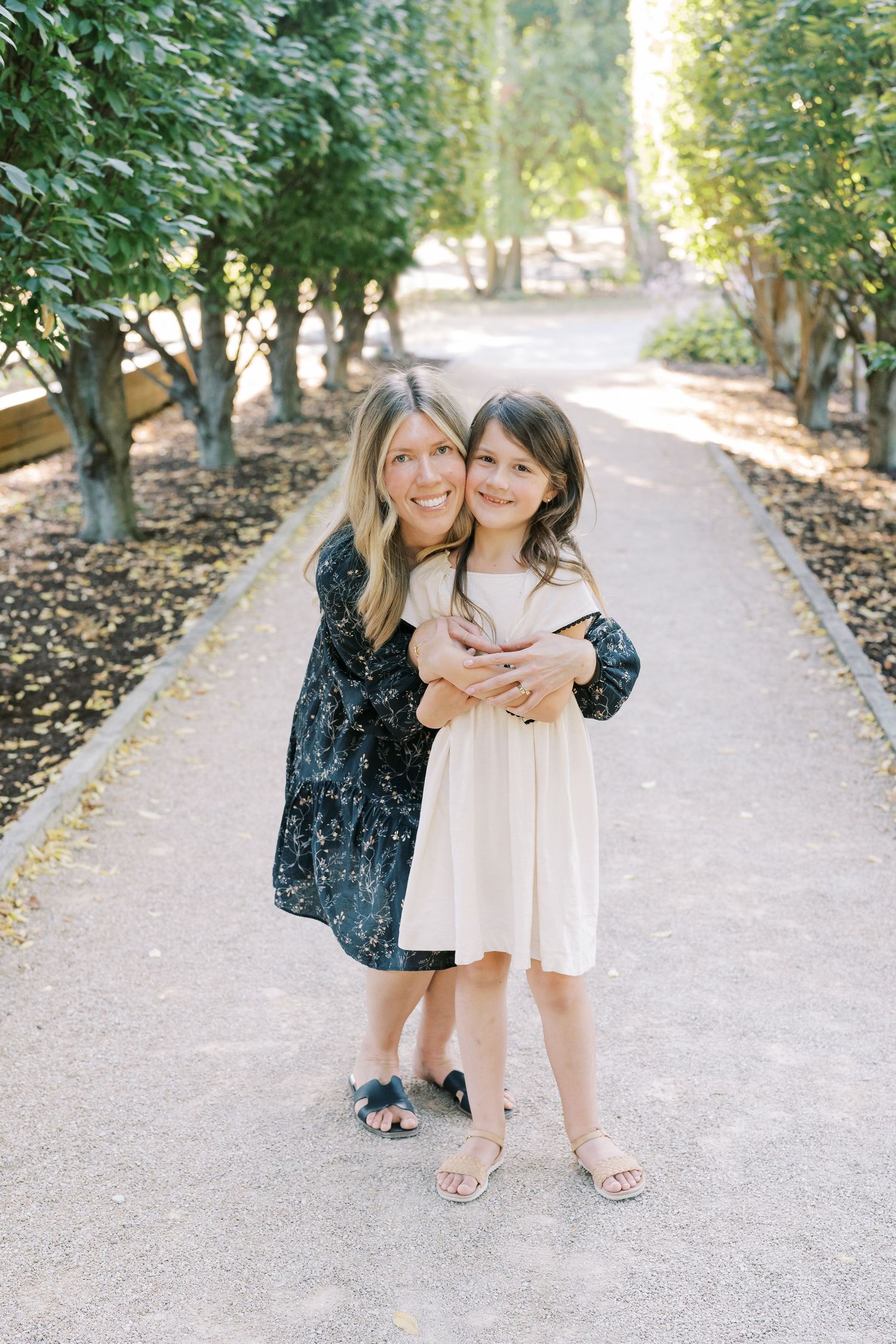 Candid family moments captured on garden walking path.