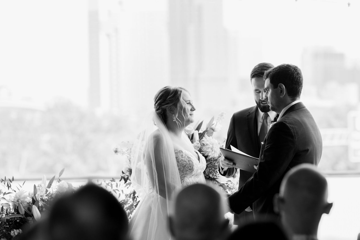 A series of black and white wedding photos showing intimate moments between a couple during their celebration.
