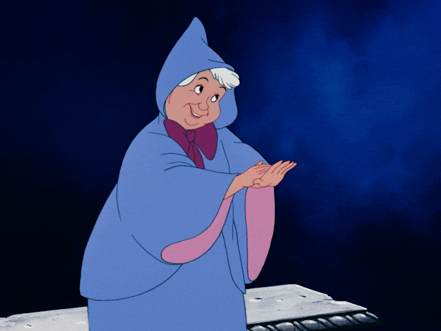 Fairy Godmother animated Disney character in blue hooded cloak clapping hands with a warm smile.