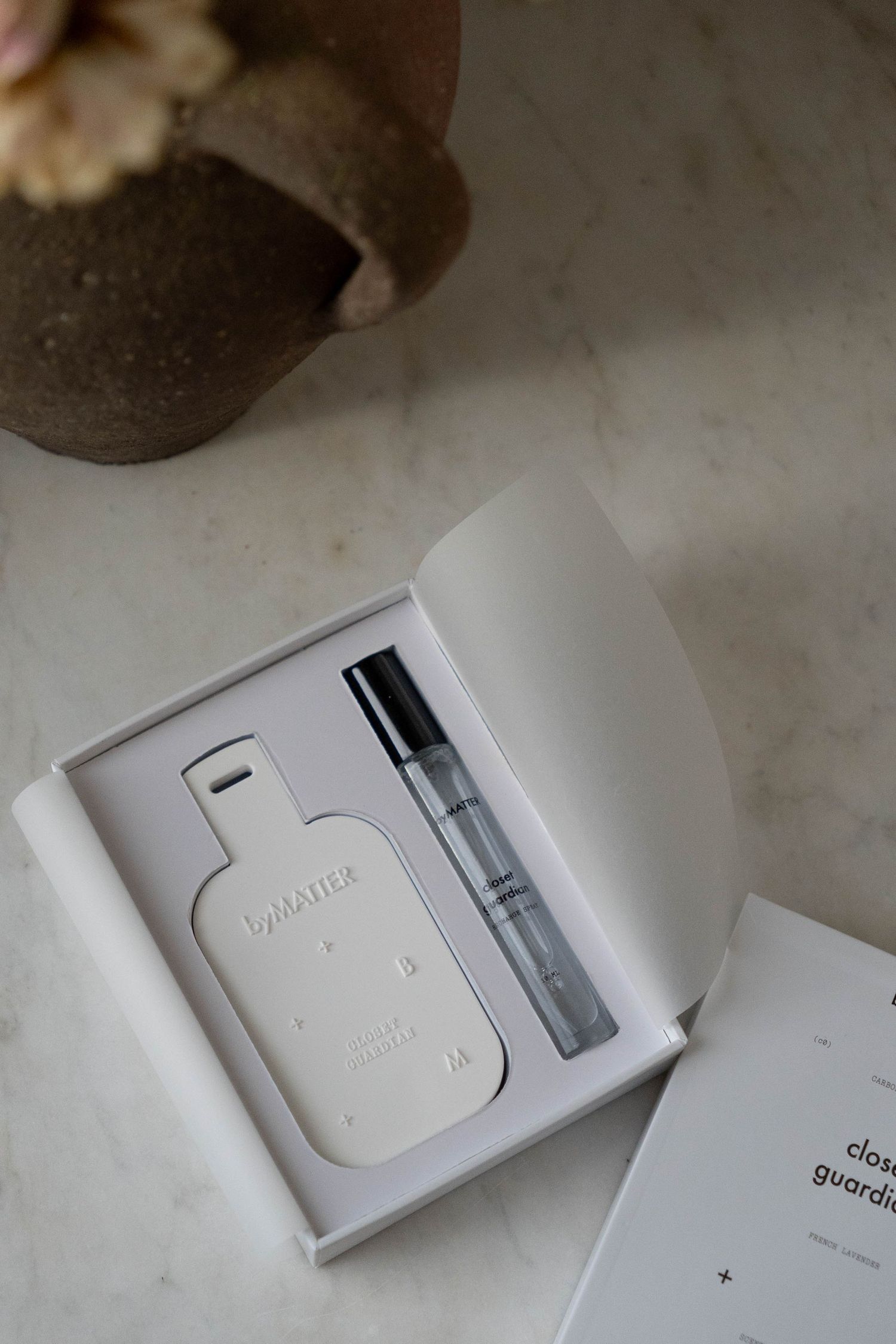 byMATTER perfume sample kit in open white box with small spray bottle on marble surface.