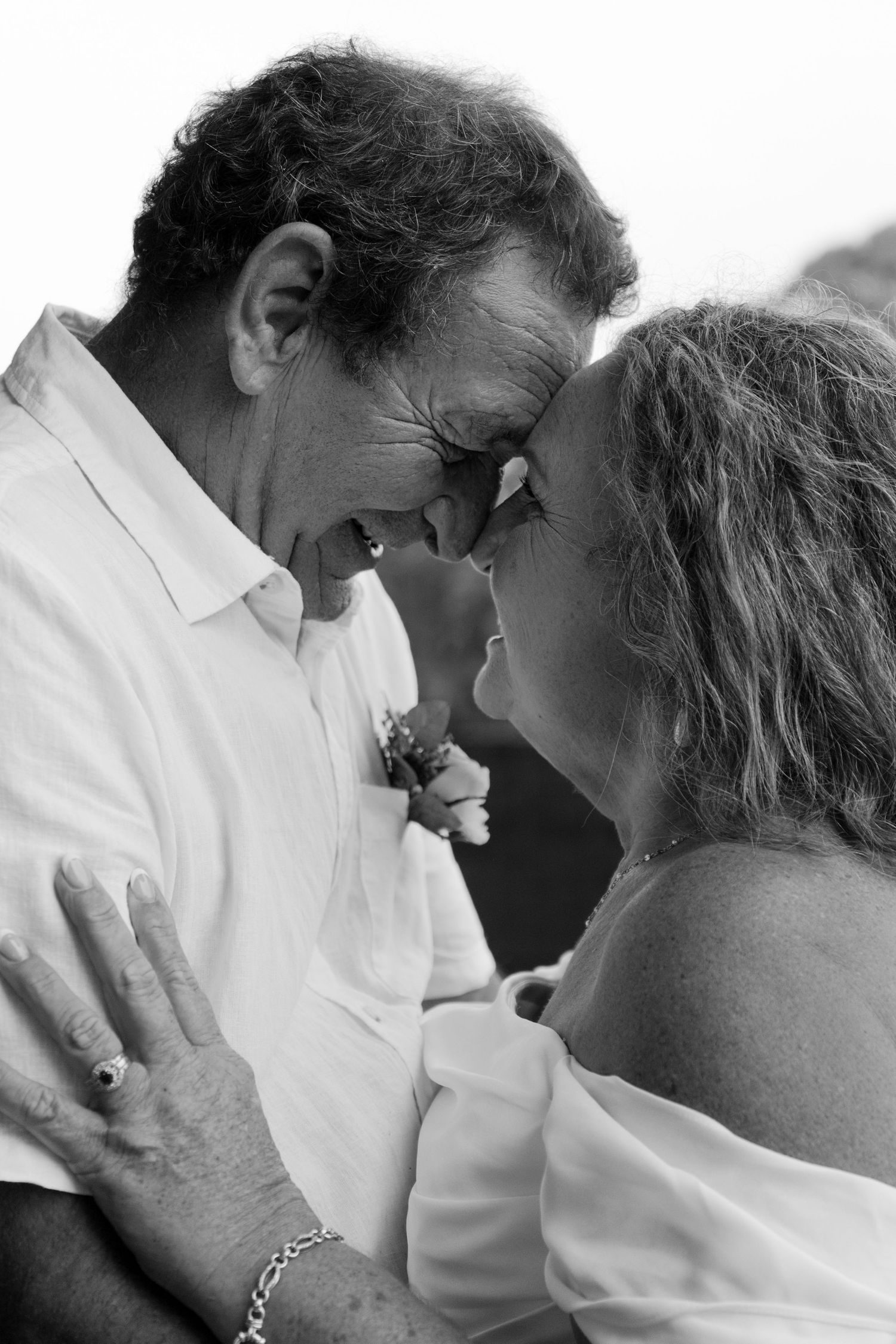 Older couple sharing a quiet moment during wedding photography session.