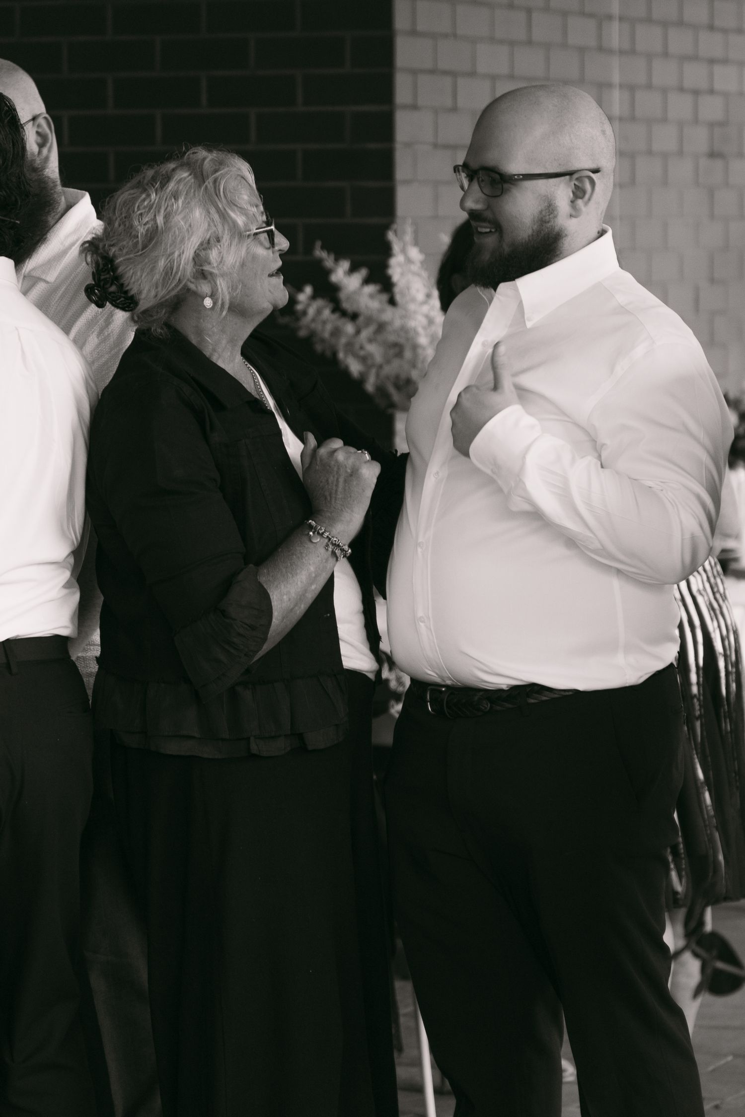 Wedding guests chatting during an outdoor celebration.