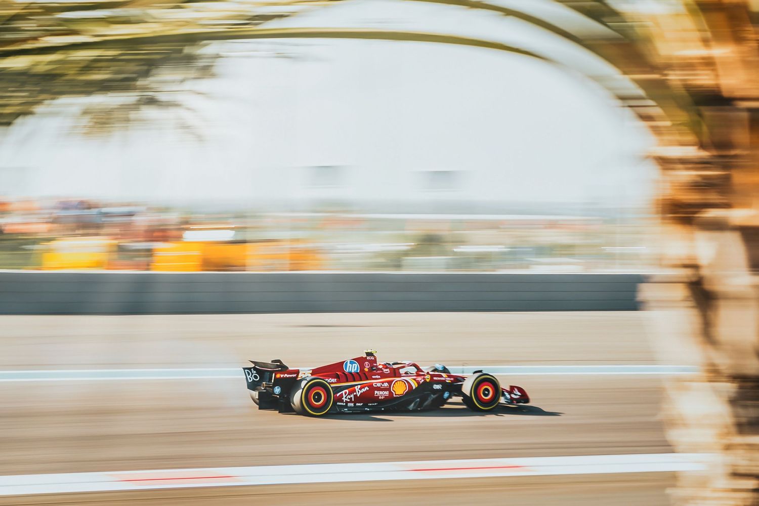 Ferrari Formula 1 car racing at high speed on track at Abu Dhabi Grand Prix.