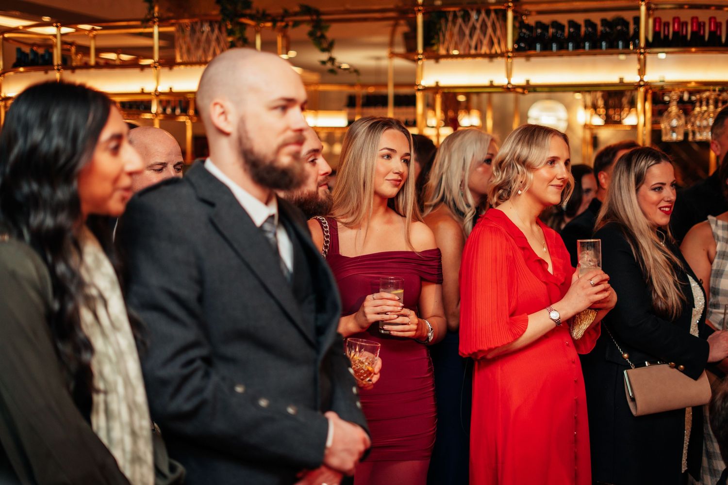 Guests socializing and enjoying drinks at an upscale Burns Night evening reception event.