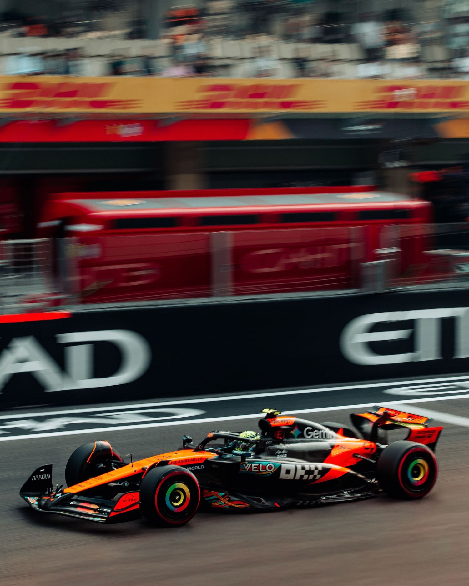McLaren F1 orange livery car racing at high speed at Abu Dhabi Grand Prix Yas Marina Circuit.
