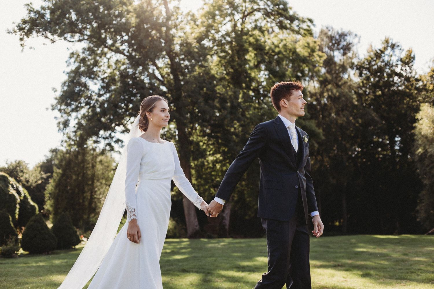 Wedding couple walking with sunset background