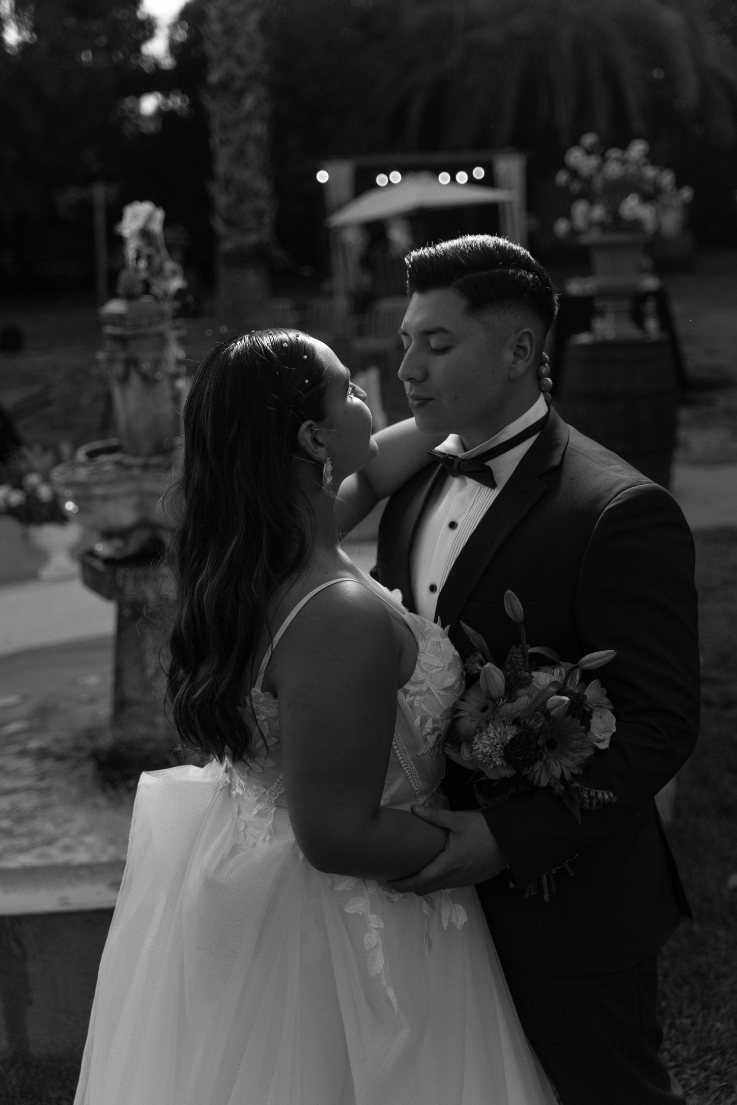 Black and white wedding portraits capture romantic moments between newlyweds.