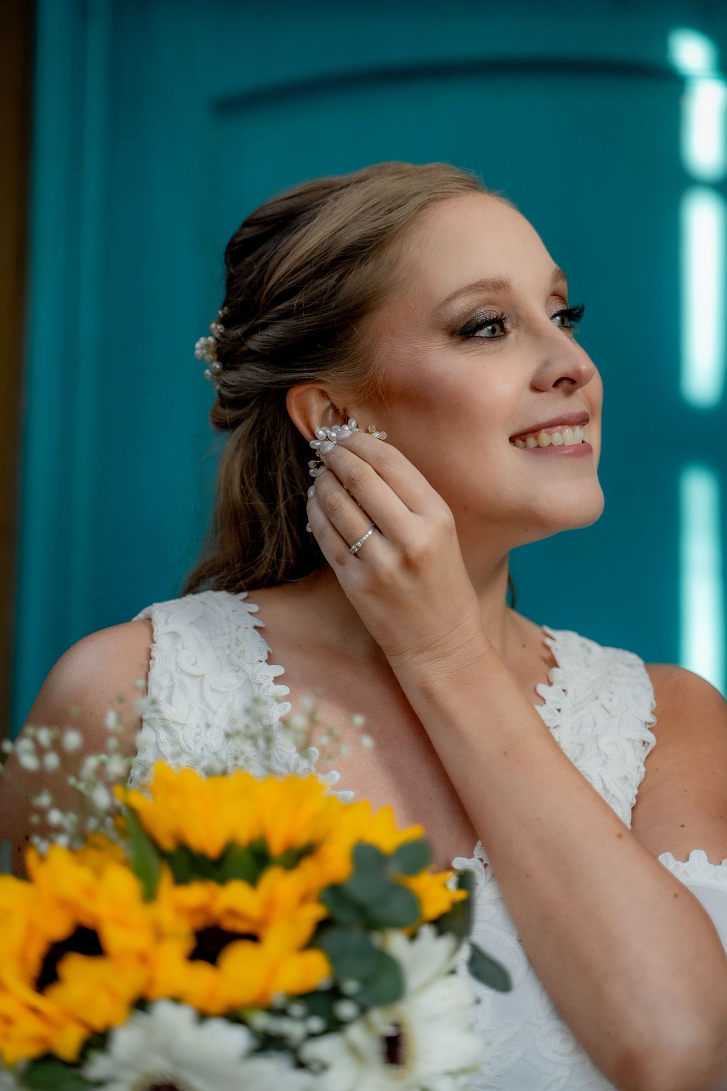 Close-up of bridal details with sunflowers and white floral bouquet.