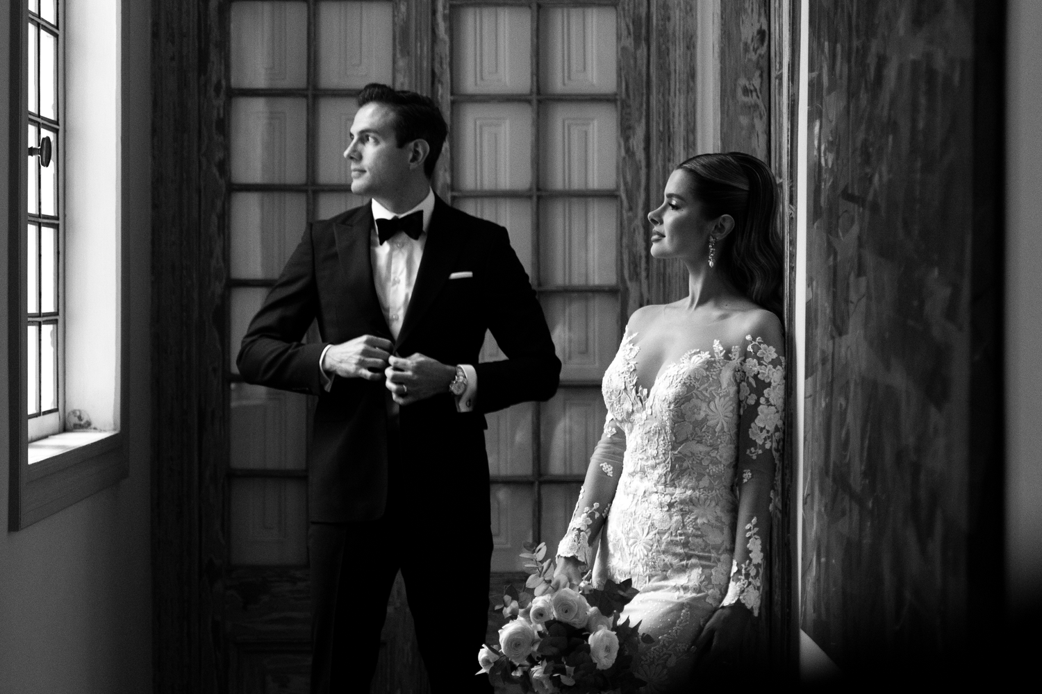 A black and white wedding photo series showing intimate moments between a bride and groom in an elegant indoor setting.