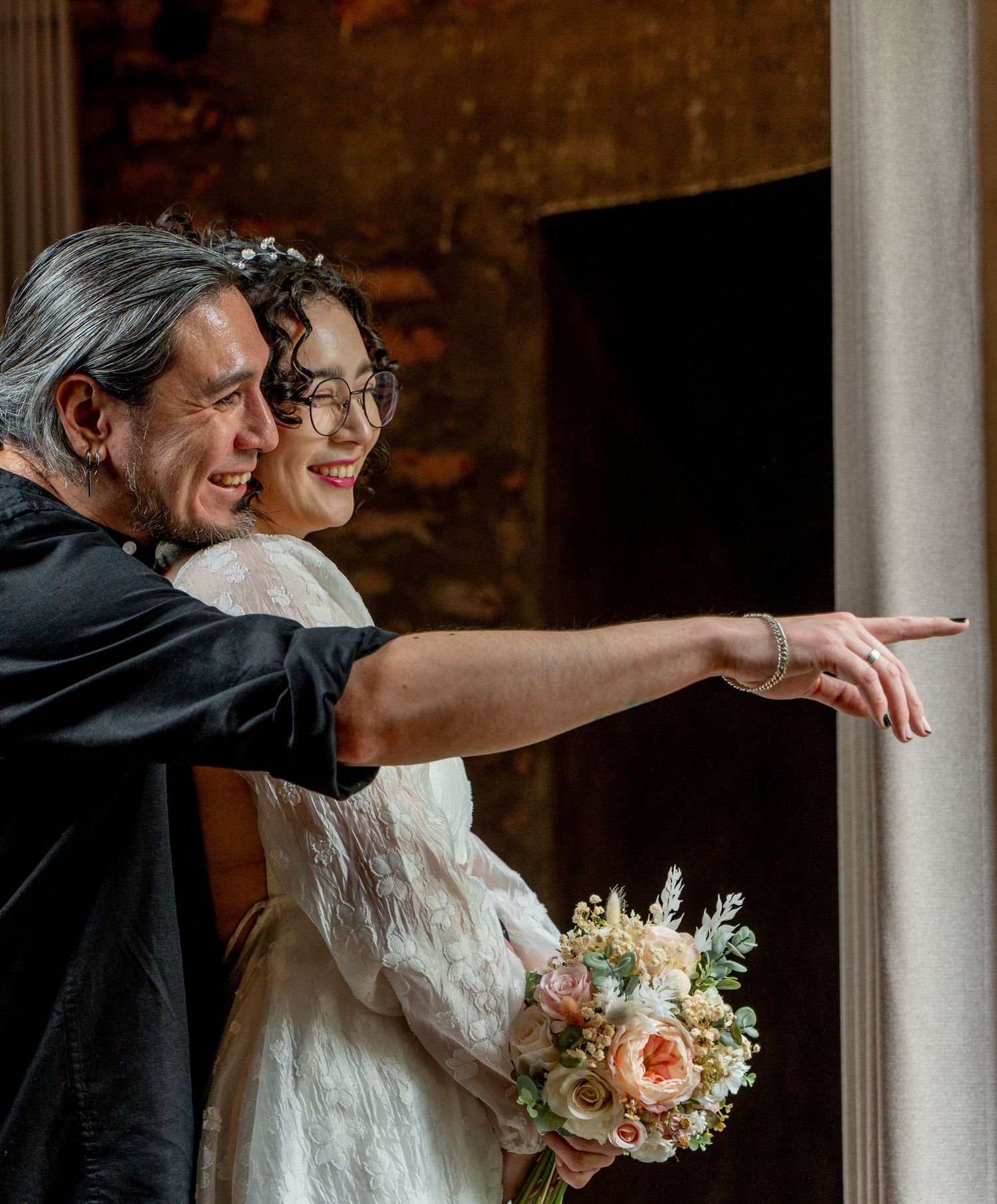 A romantic wedding moment with a beautiful bouquet of peach and white roses.