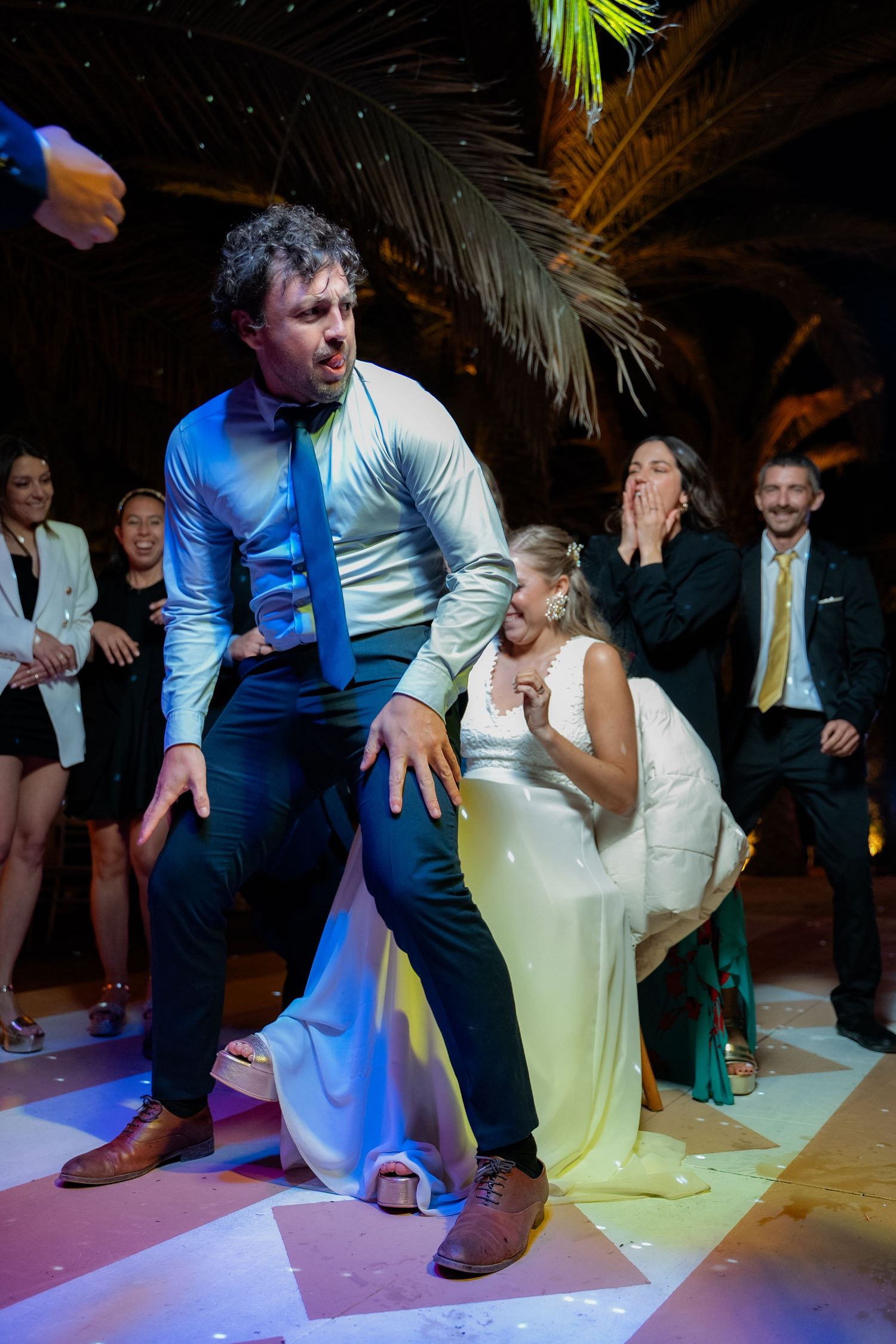 Wedding reception dance floor comes alive with energetic dancing and celebrations.
