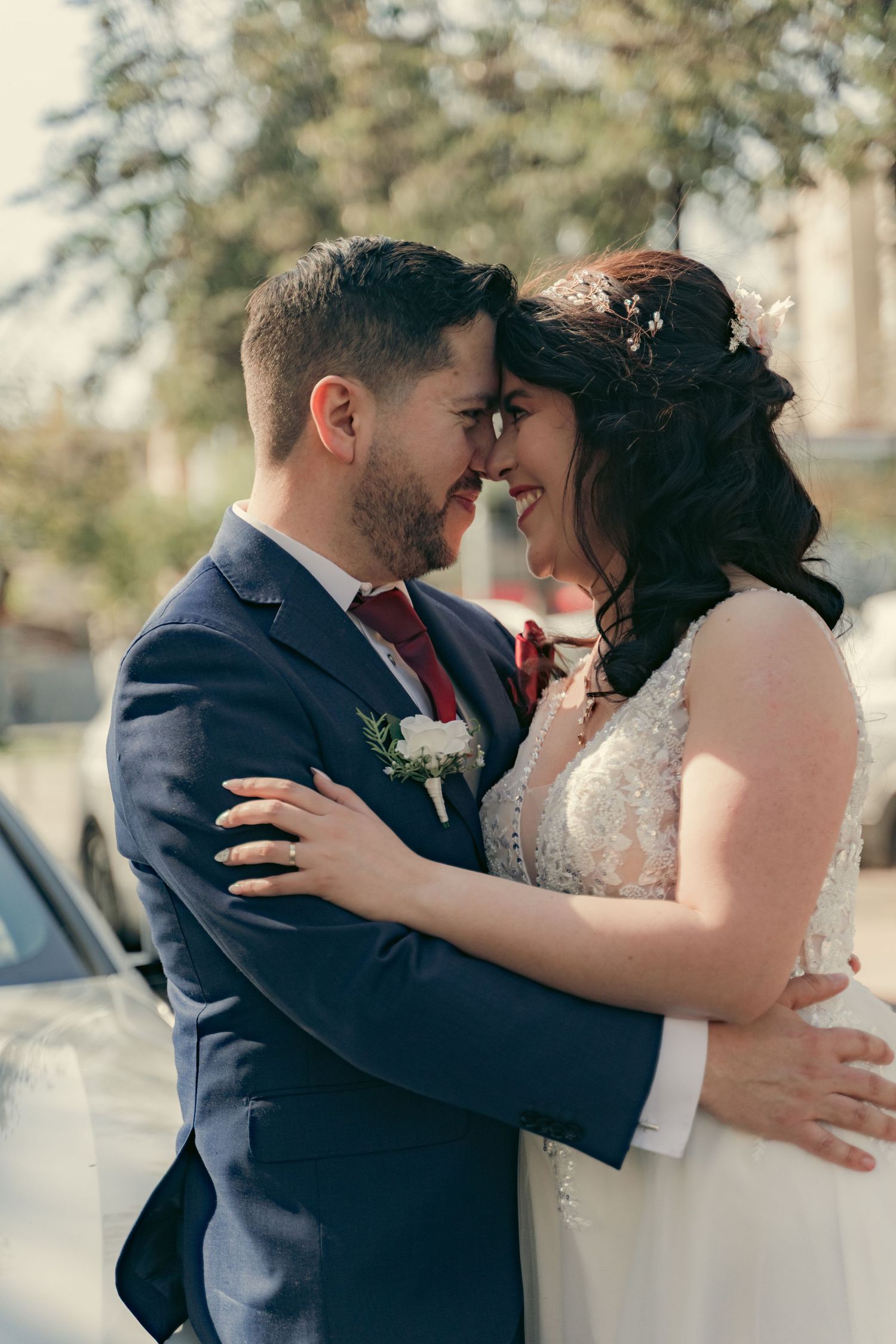 Romantic outdoor wedding portraits showing tender moments between newlyweds.