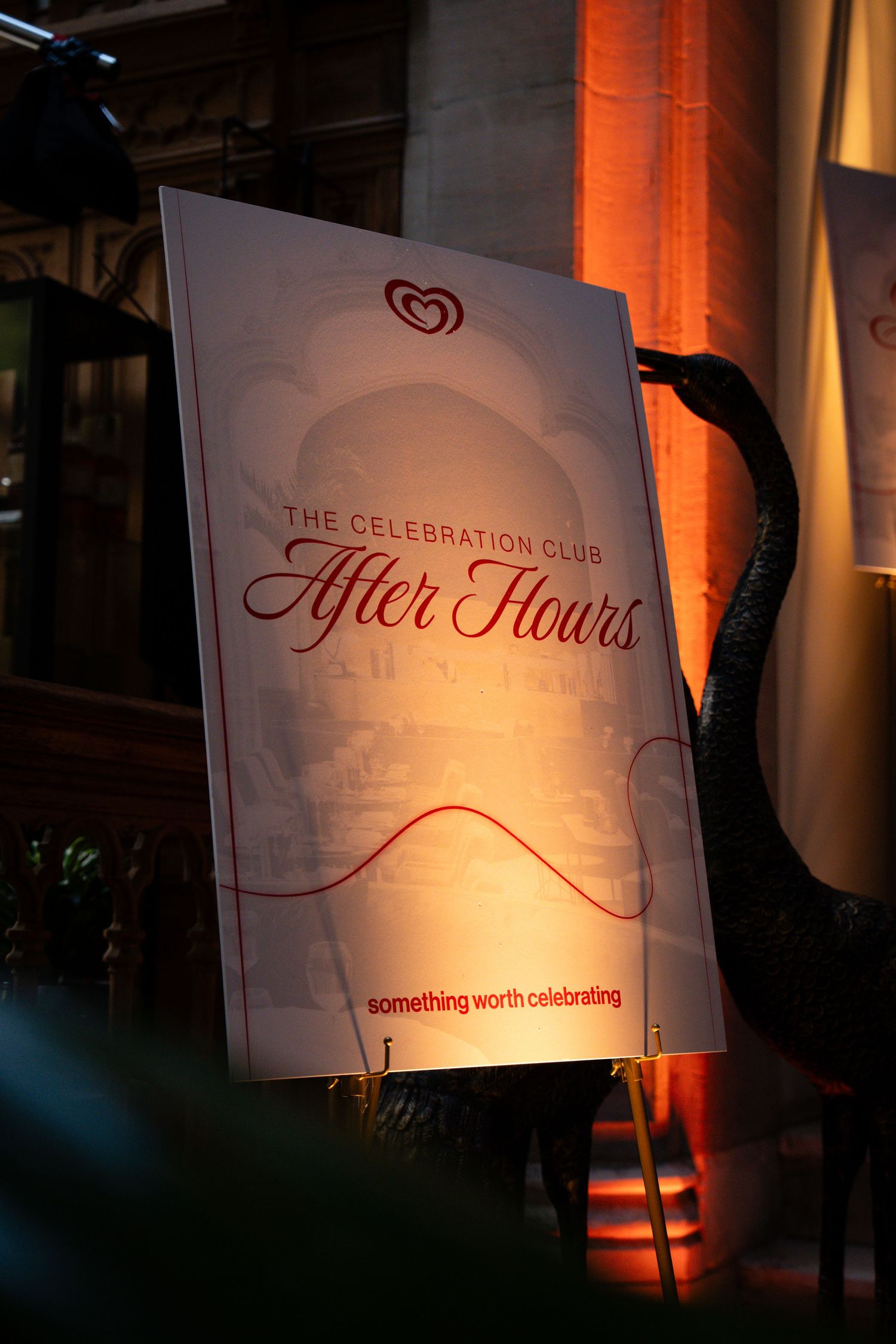Illuminated event signage for 'The Celebration Club' and 'Tyler Hours' displayed against dark background with orange lighting.