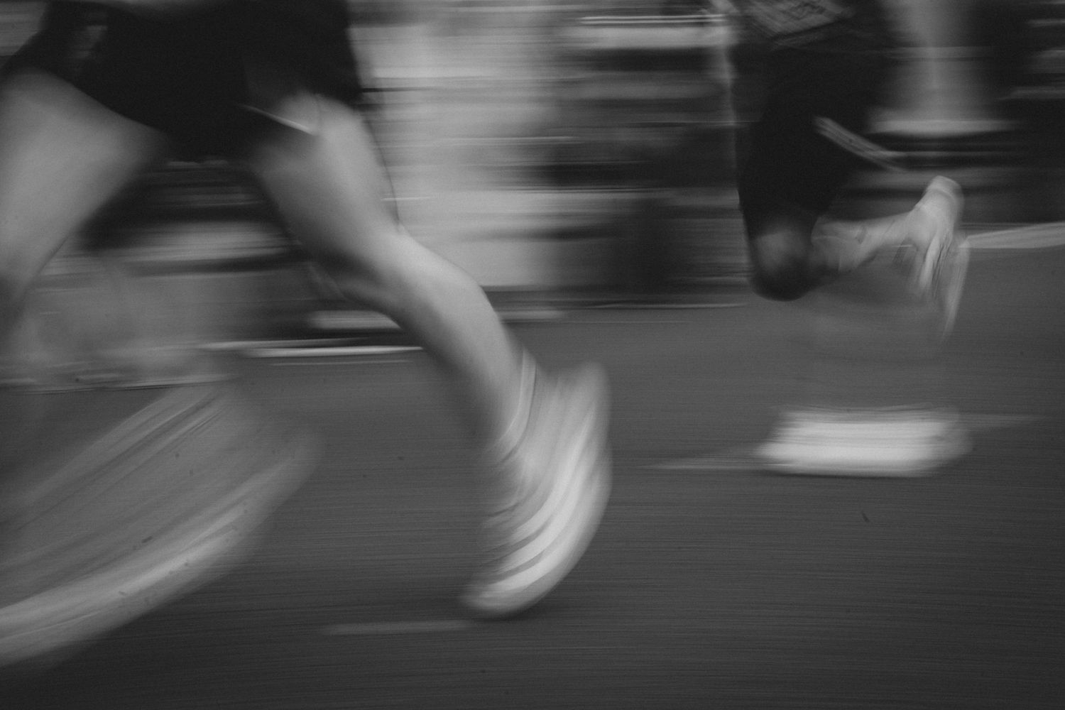 Motion blur of running shoes and legs during a race event.