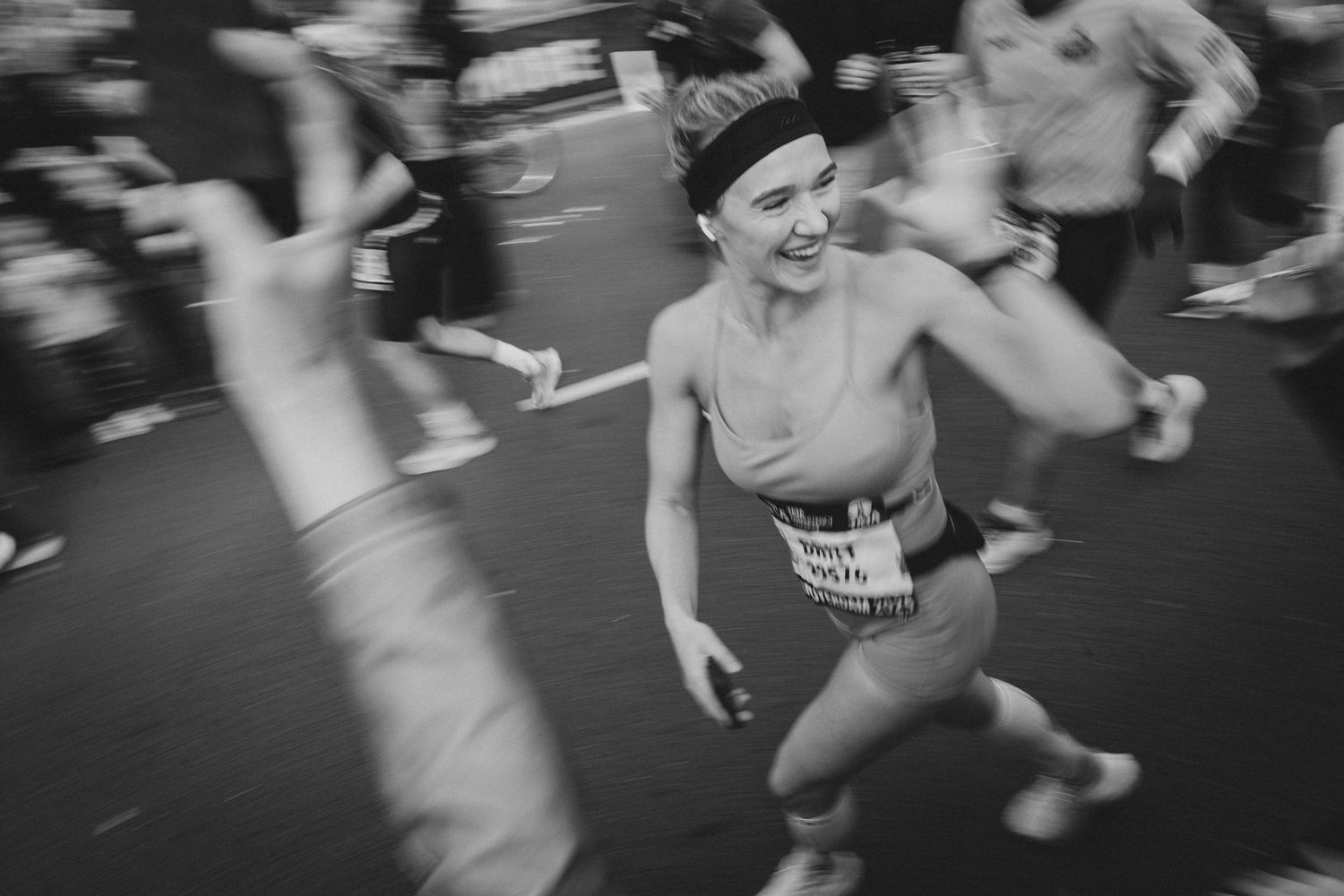 Runner showing intense emotion and enthusiasm during marathon race.