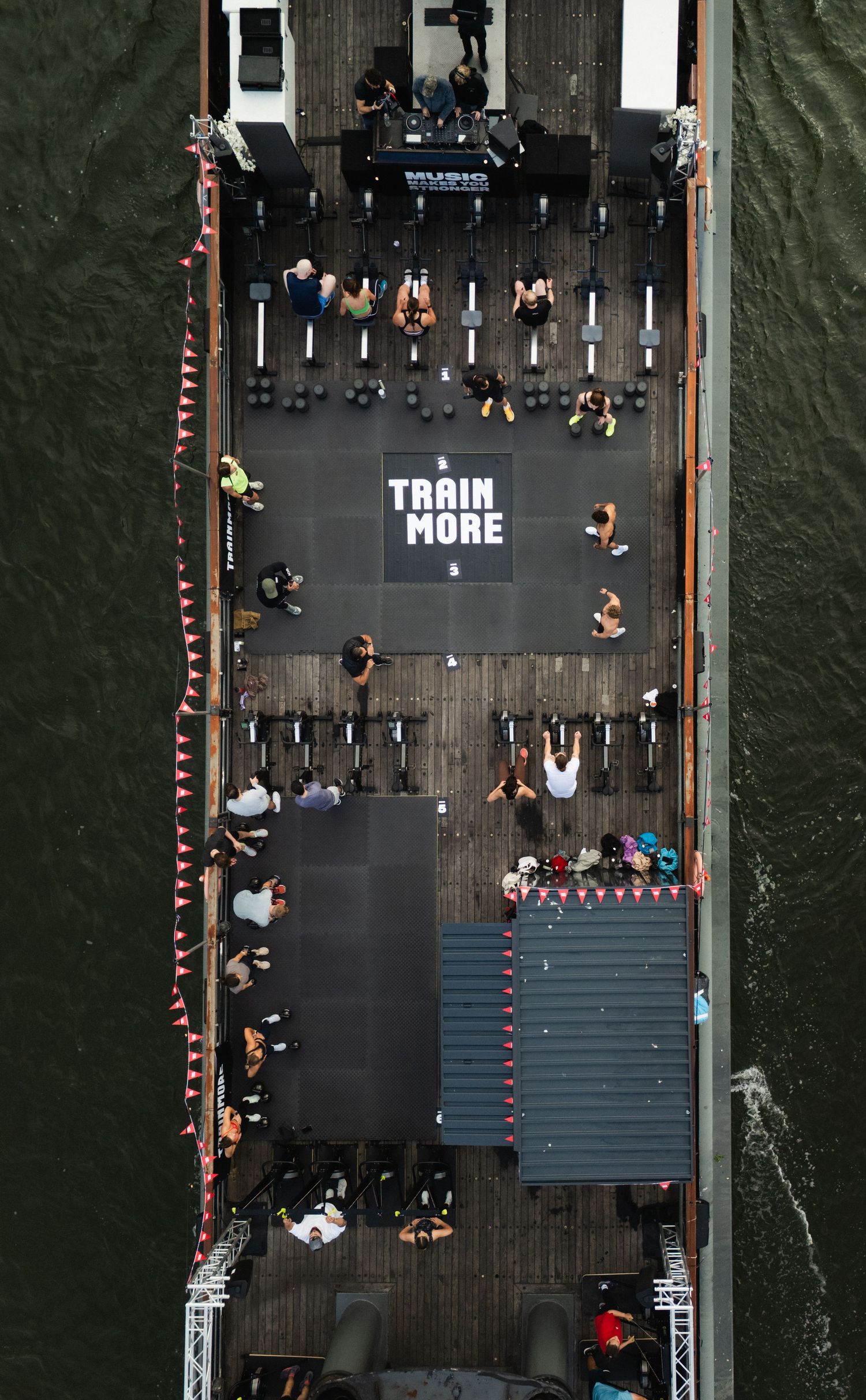 Aerial view of a floating gym barge on a river with 