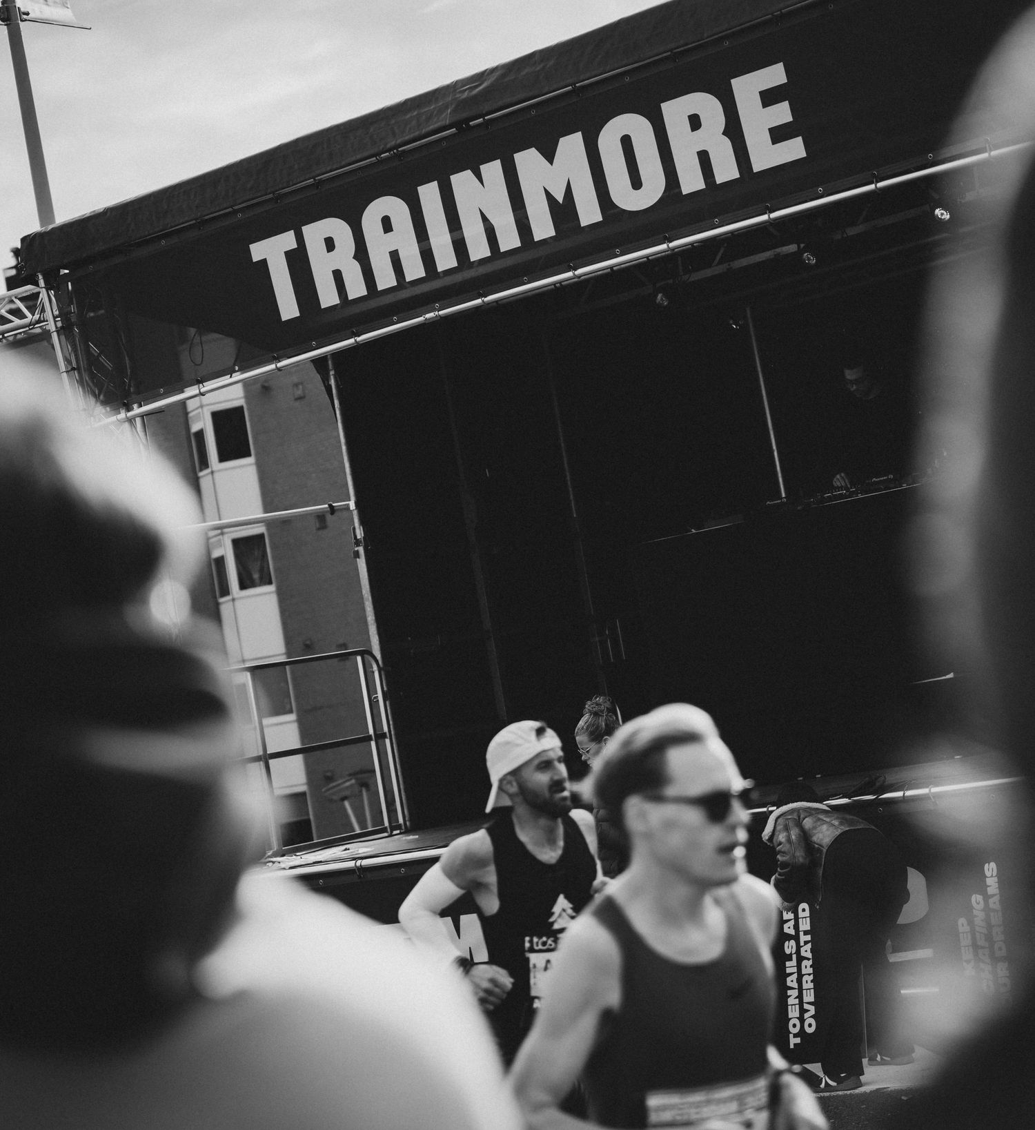 Black and white photo of Trainmore fitness event setup with speakers and equipment.