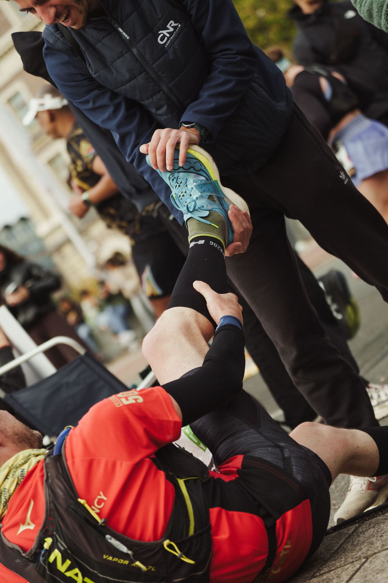 Runner receiving medical attention or massage during marathon event.