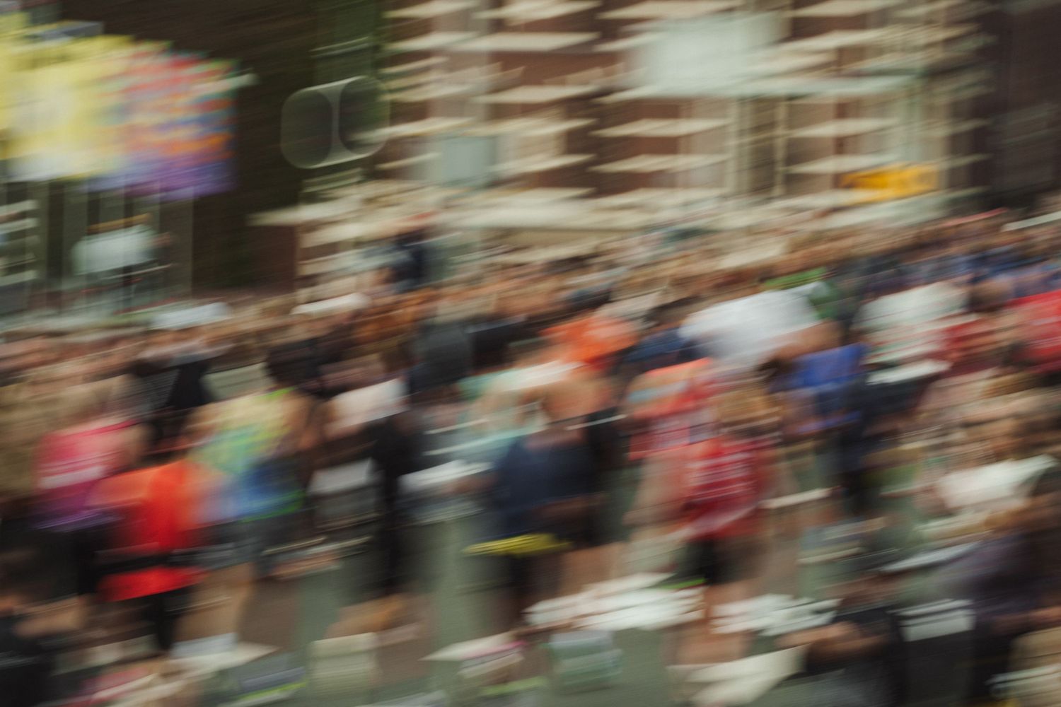 Blurred motion of marathon runners racing through city streets.