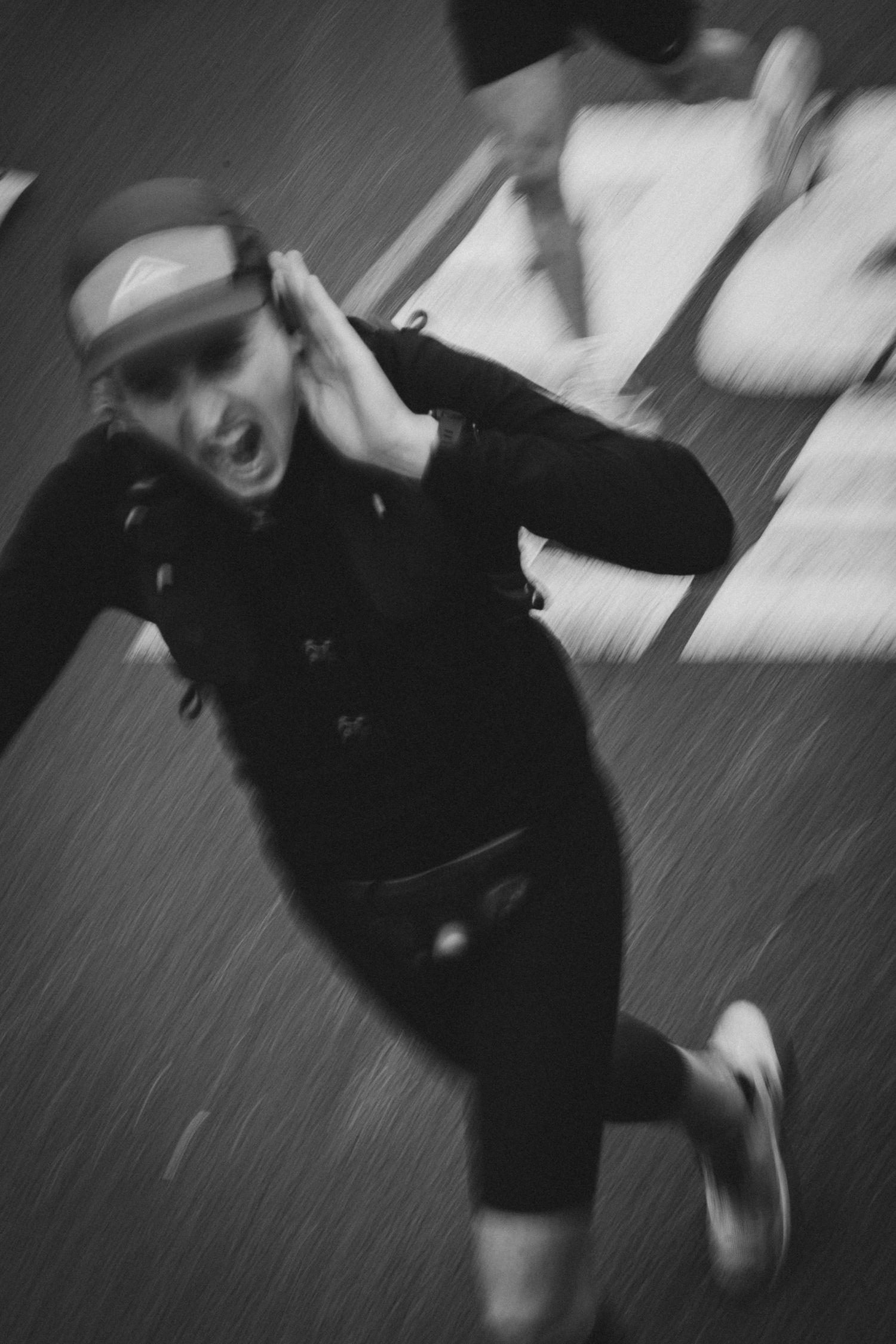 Dynamic black and white shot of runner in motion with dramatic blur effect.